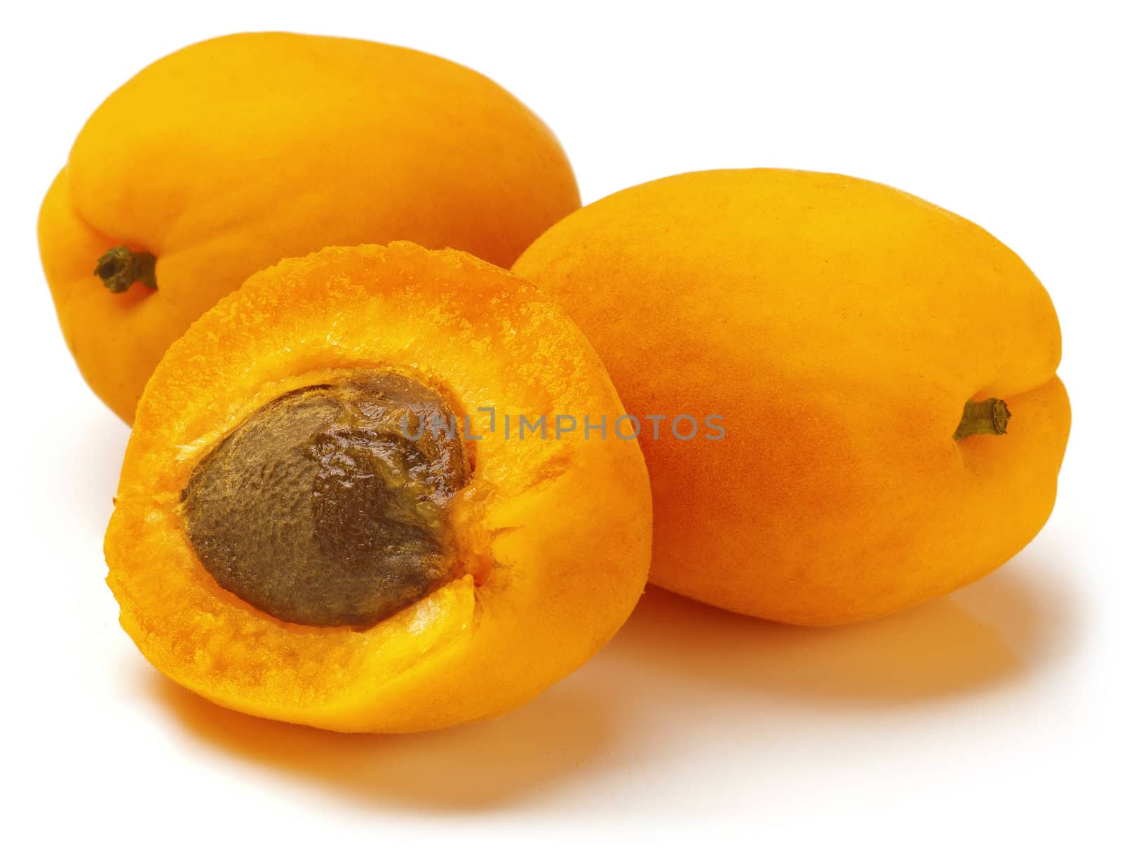 Two and the half of fresh mature apricots on white background.