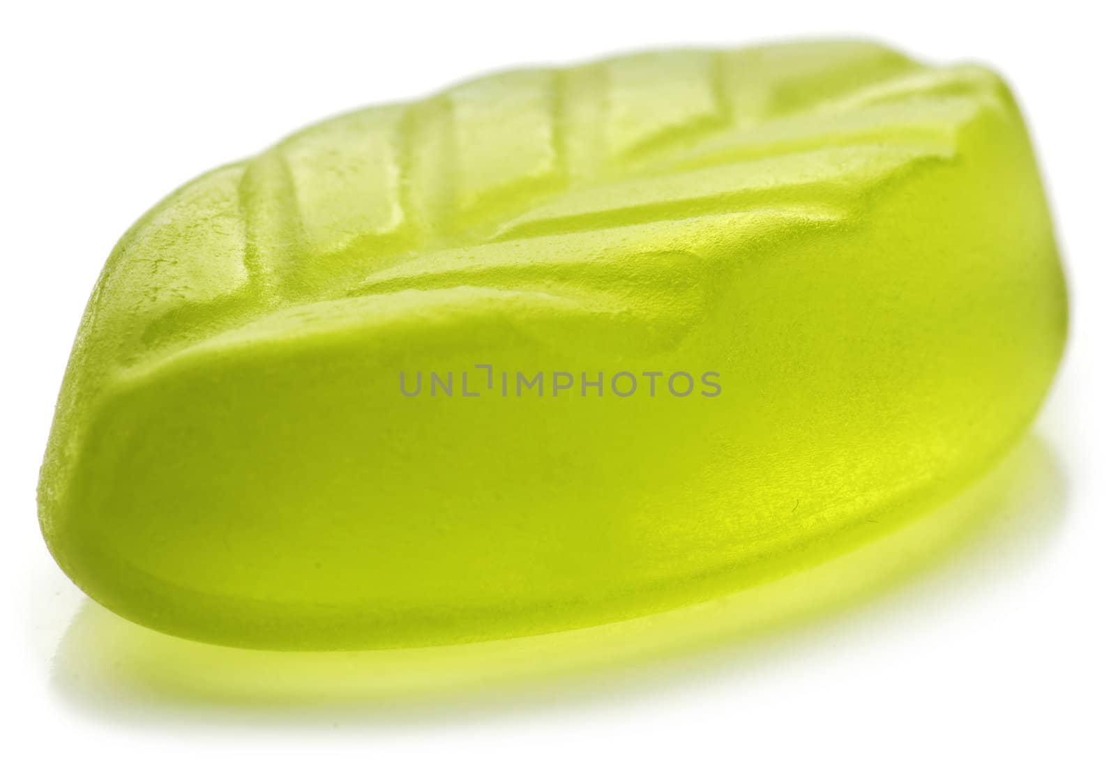 Leaf shaped jelly in green color on white background. Soft focus.