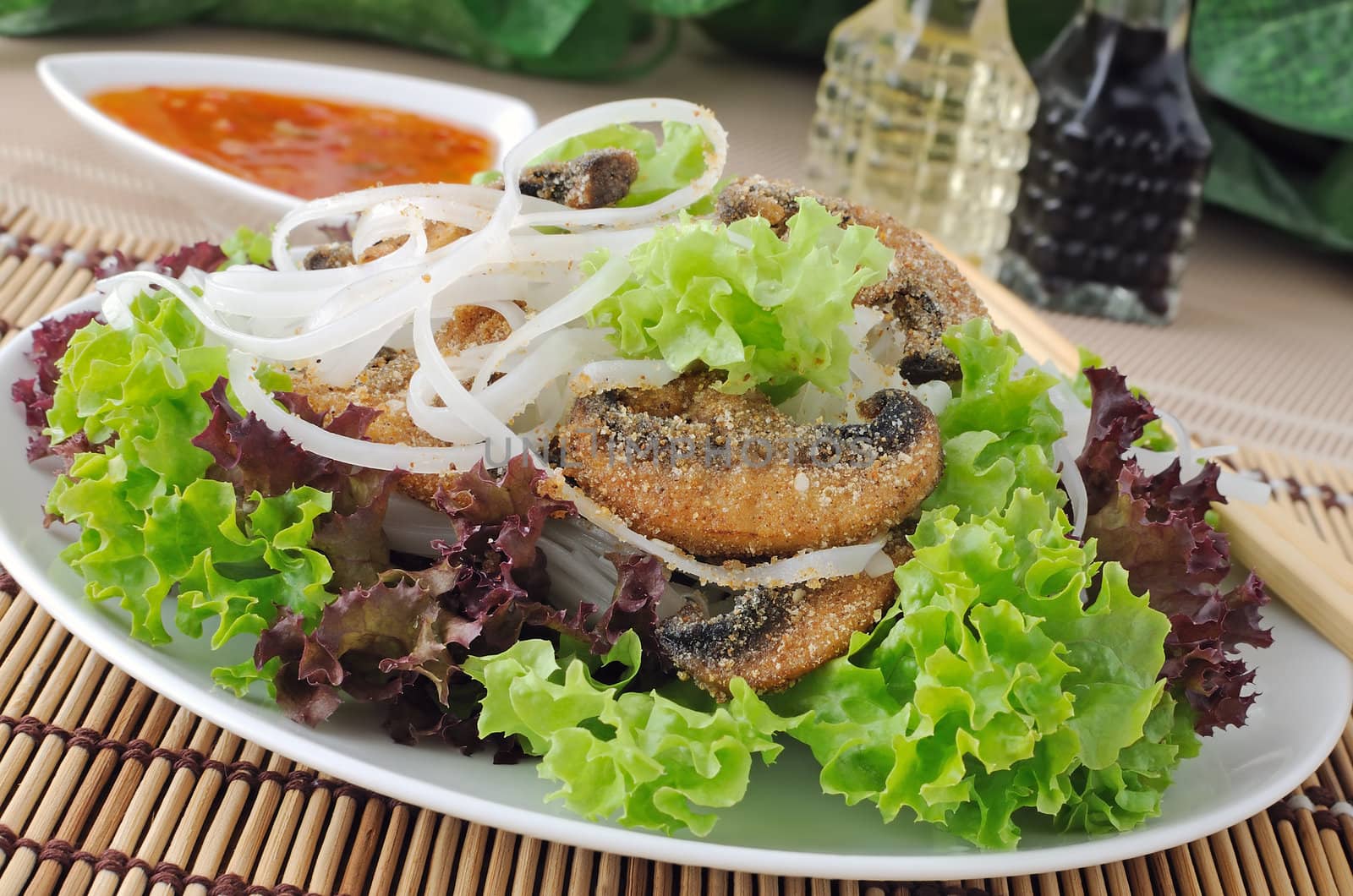 Salad of rice noodles in lettuce leaves with mushrooms in breadcrumbs