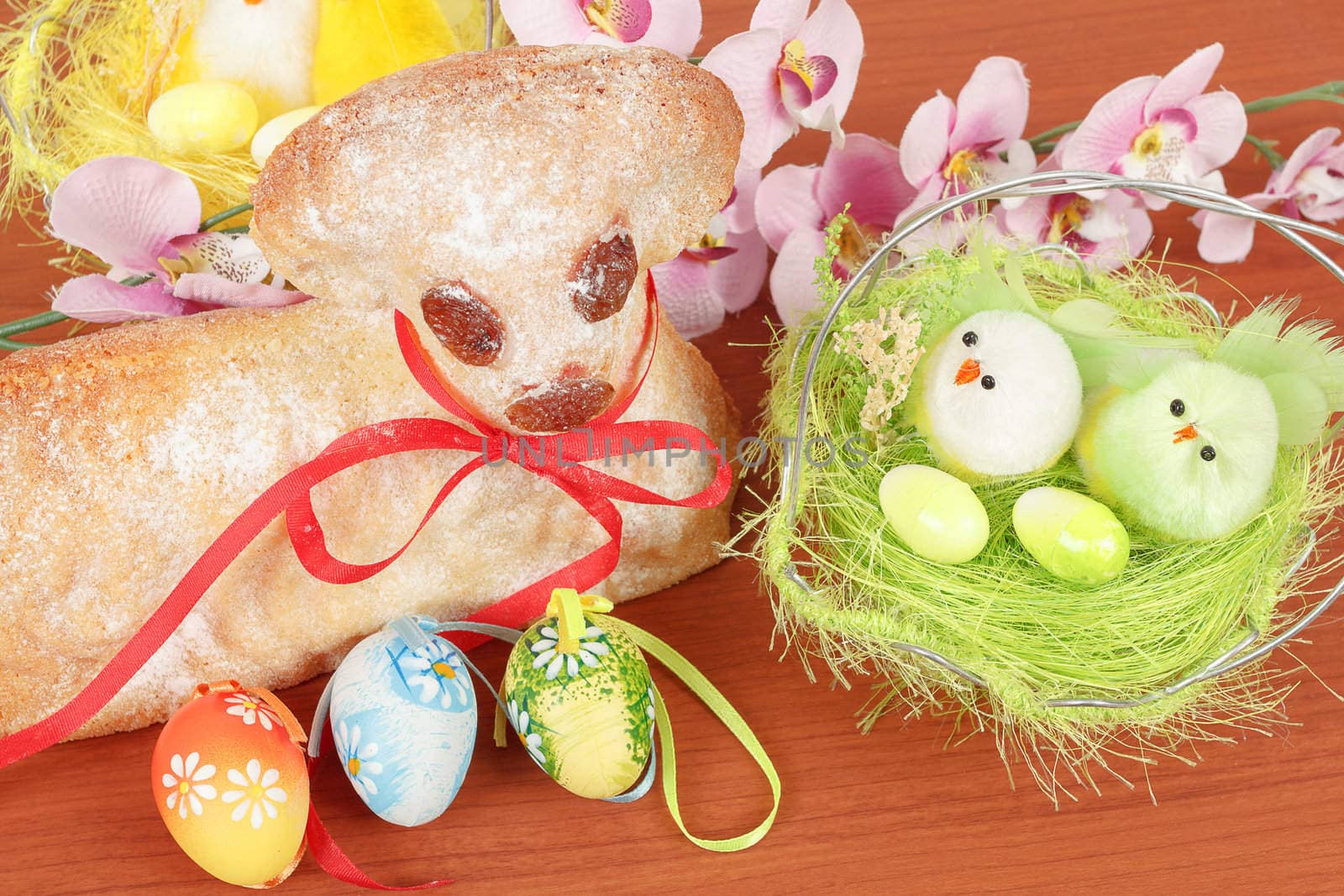 Easter lamb with painted eggs, nest and easter decorations