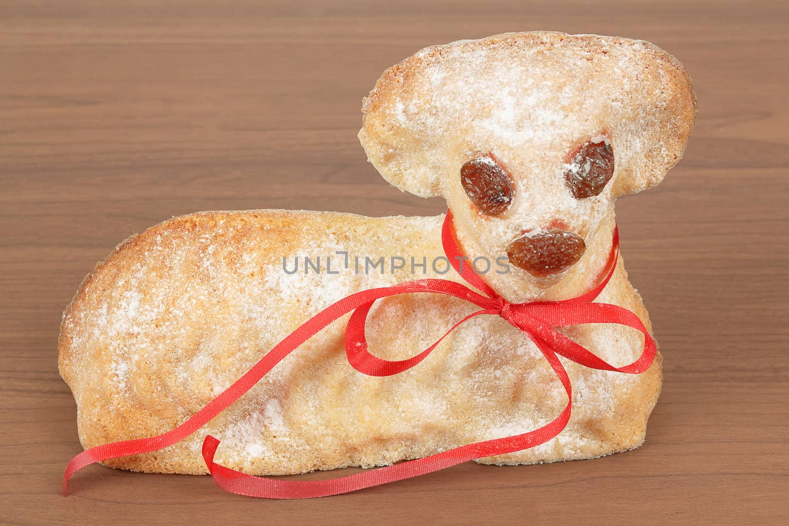 Easter lamb with powdered sugar isolated on wooden background