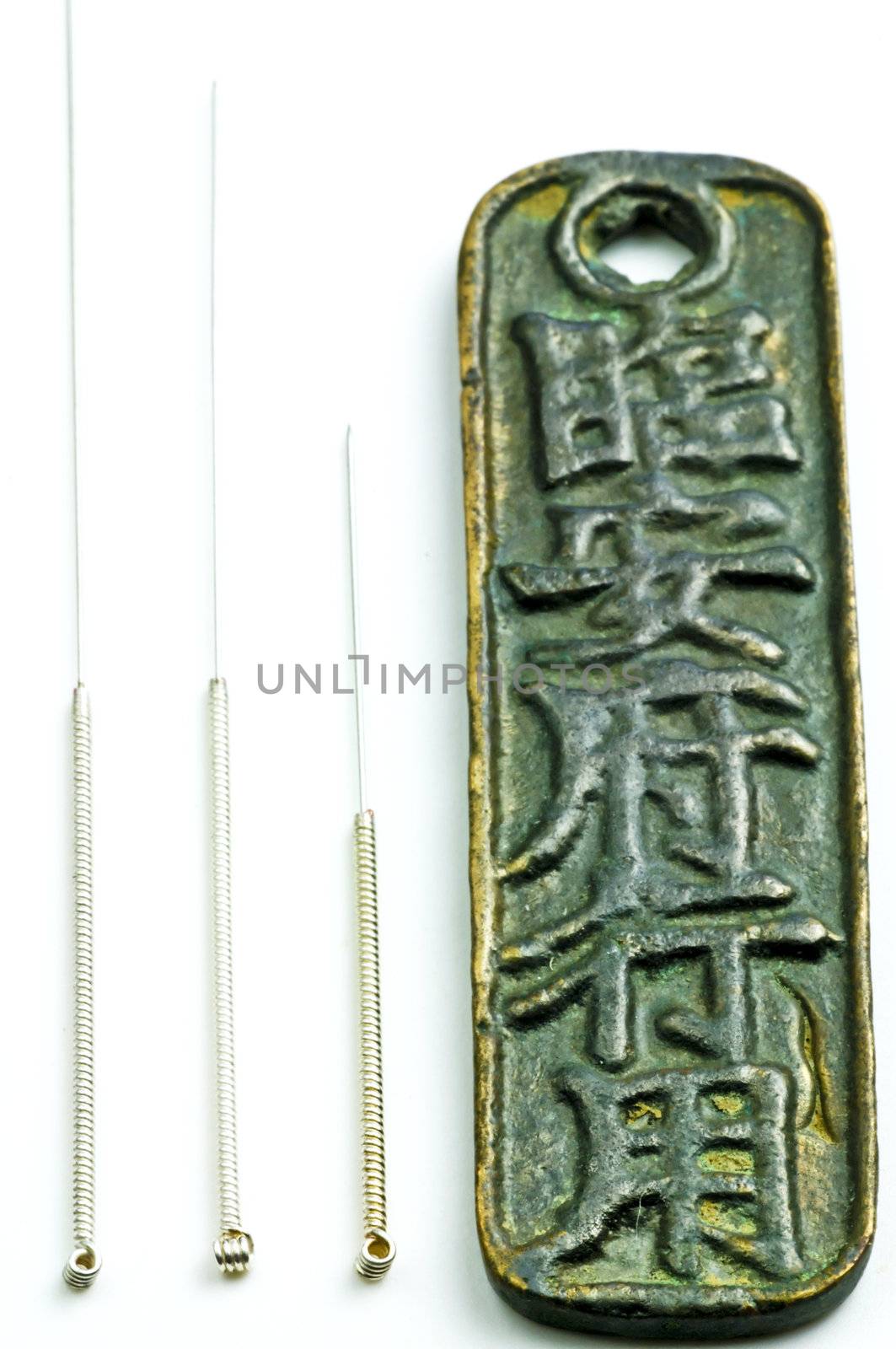 acupuncture needles on chinese coin by Jochen