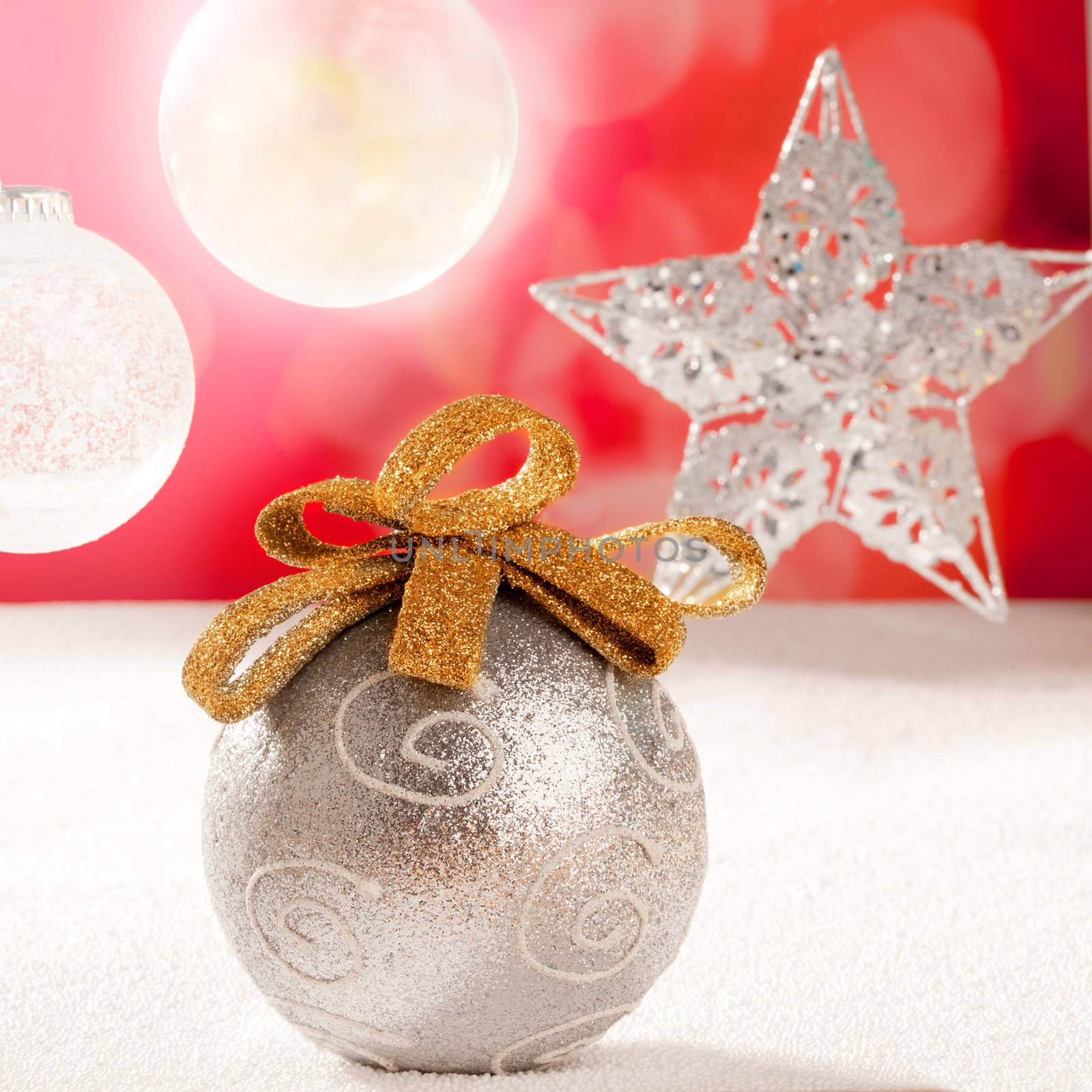 Christmas silver bauble and star on snow red background