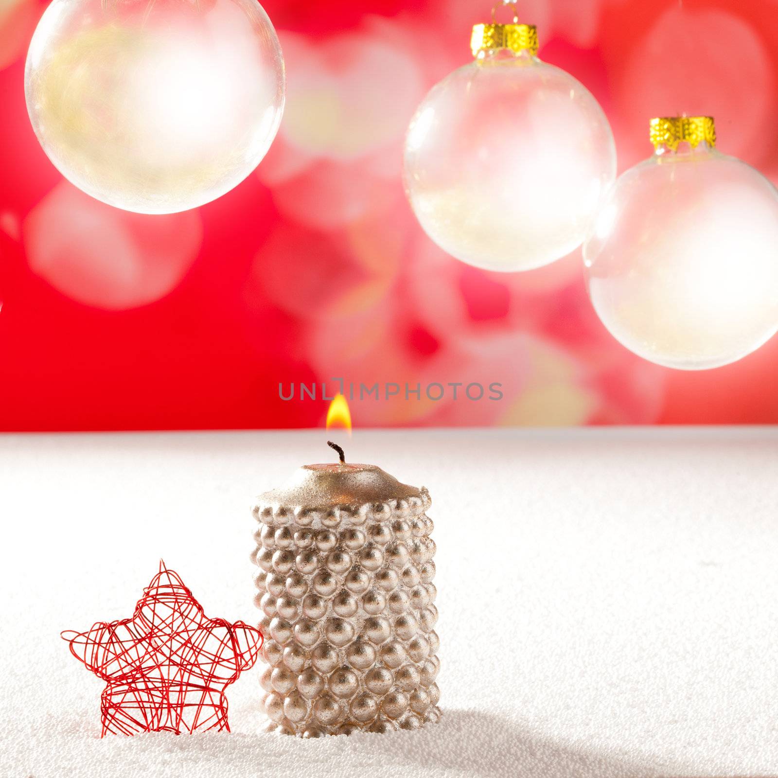 christmas silver candle and red star on snow and red with glass baubles