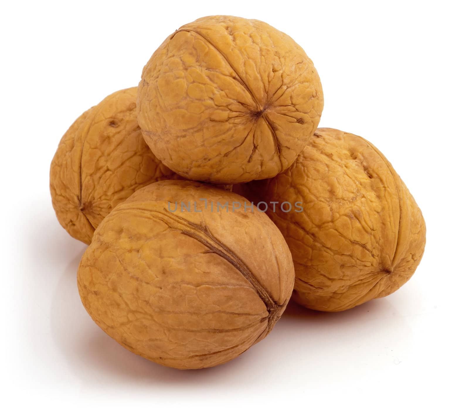 Stack of four walnuts. Isolated on a white background.