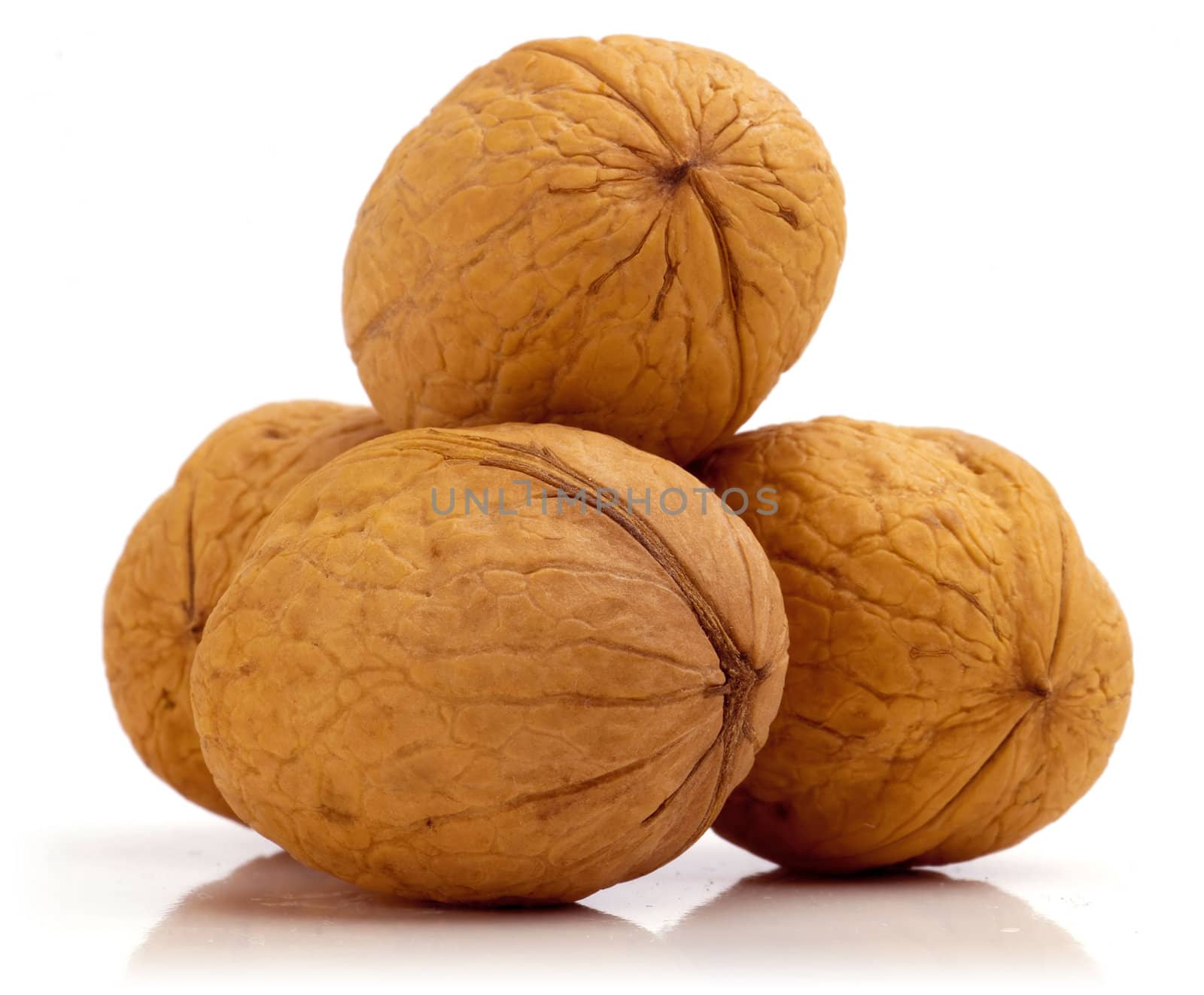 Stack of four walnuts. Isolated on a white background.