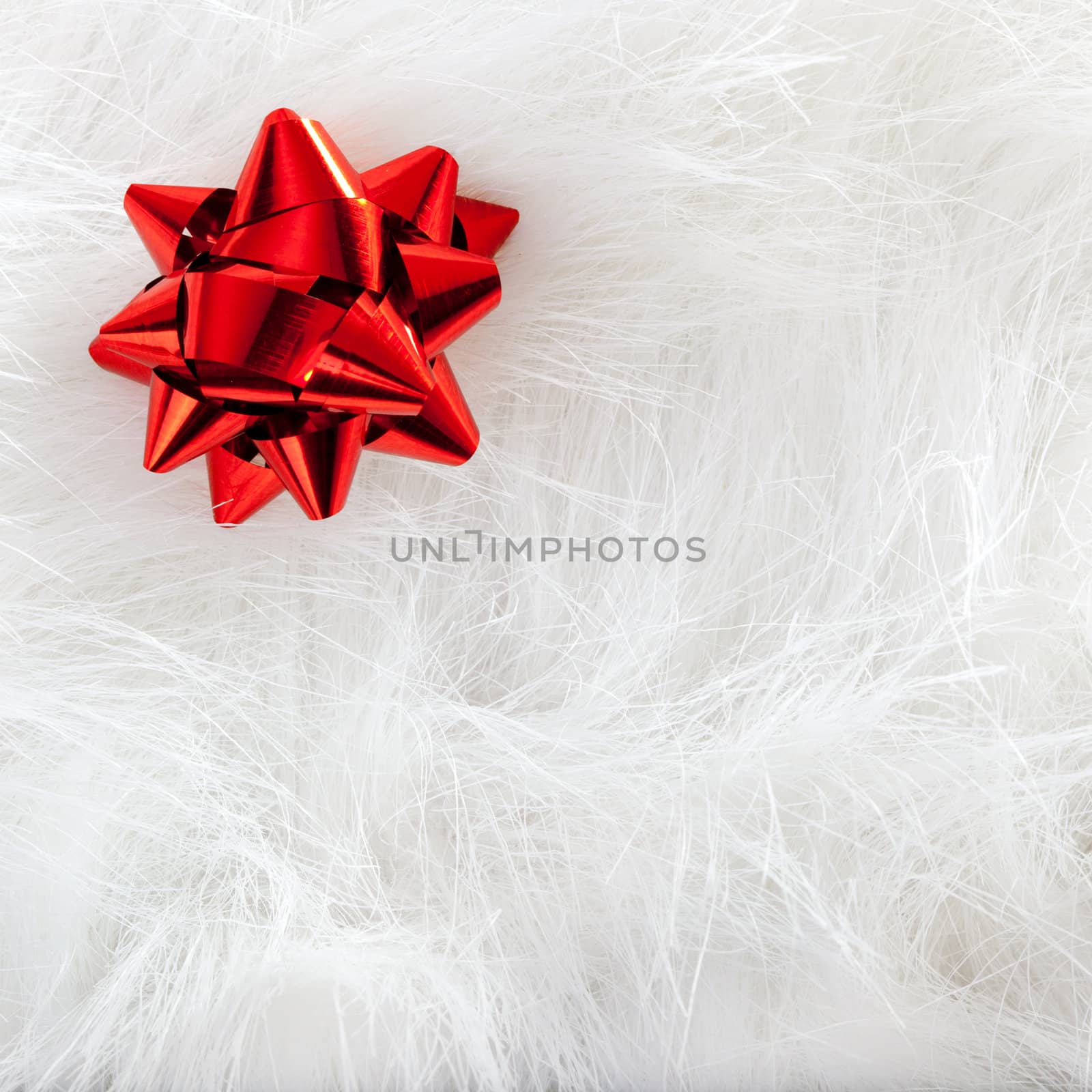 Christmas red ribbon look over white fur background