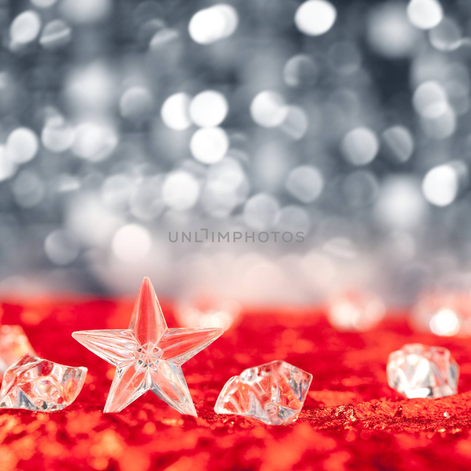 Christmas crystal star on ice cubes with blue lights bokeh background