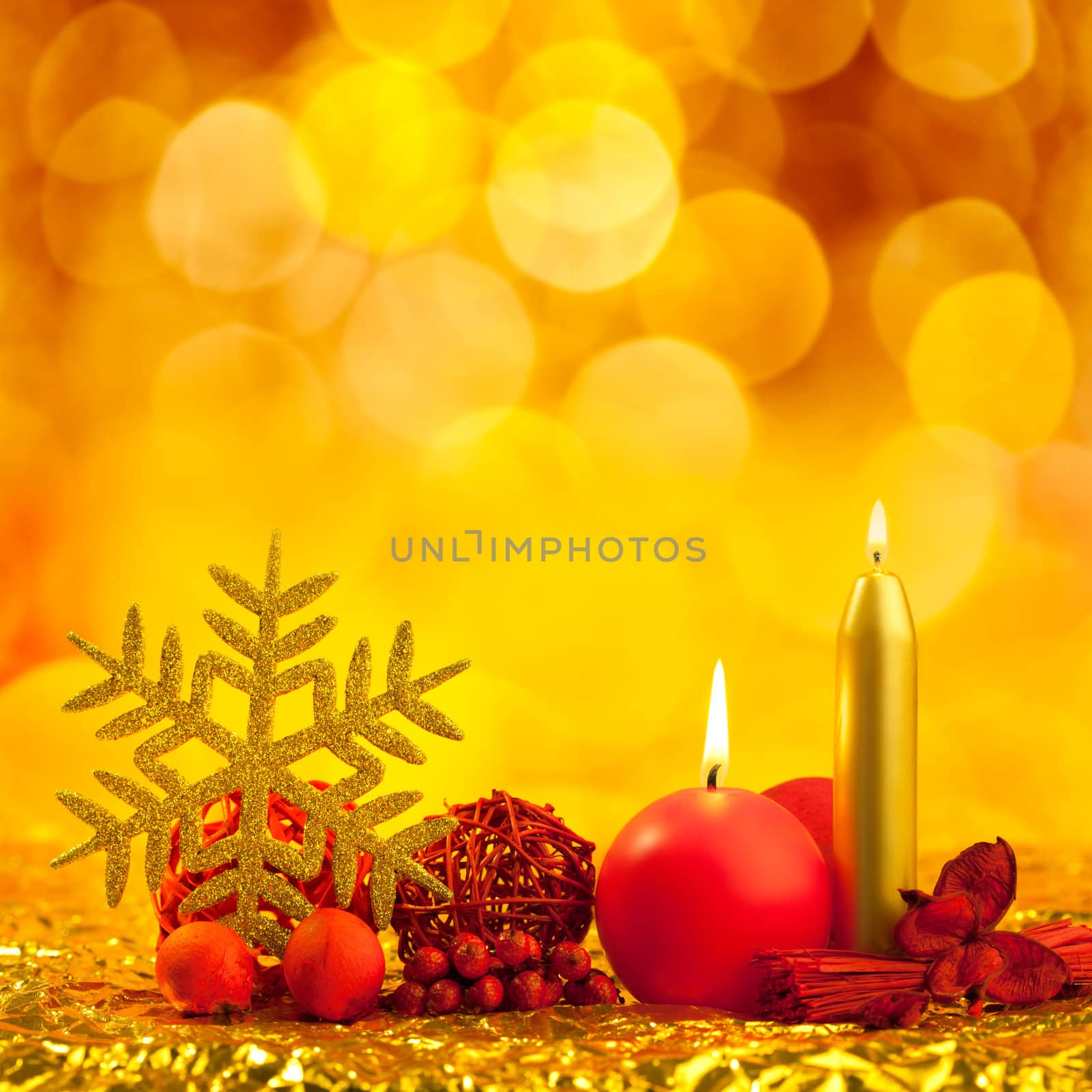 christmas golden snowflake with red candles on bokeh lights background