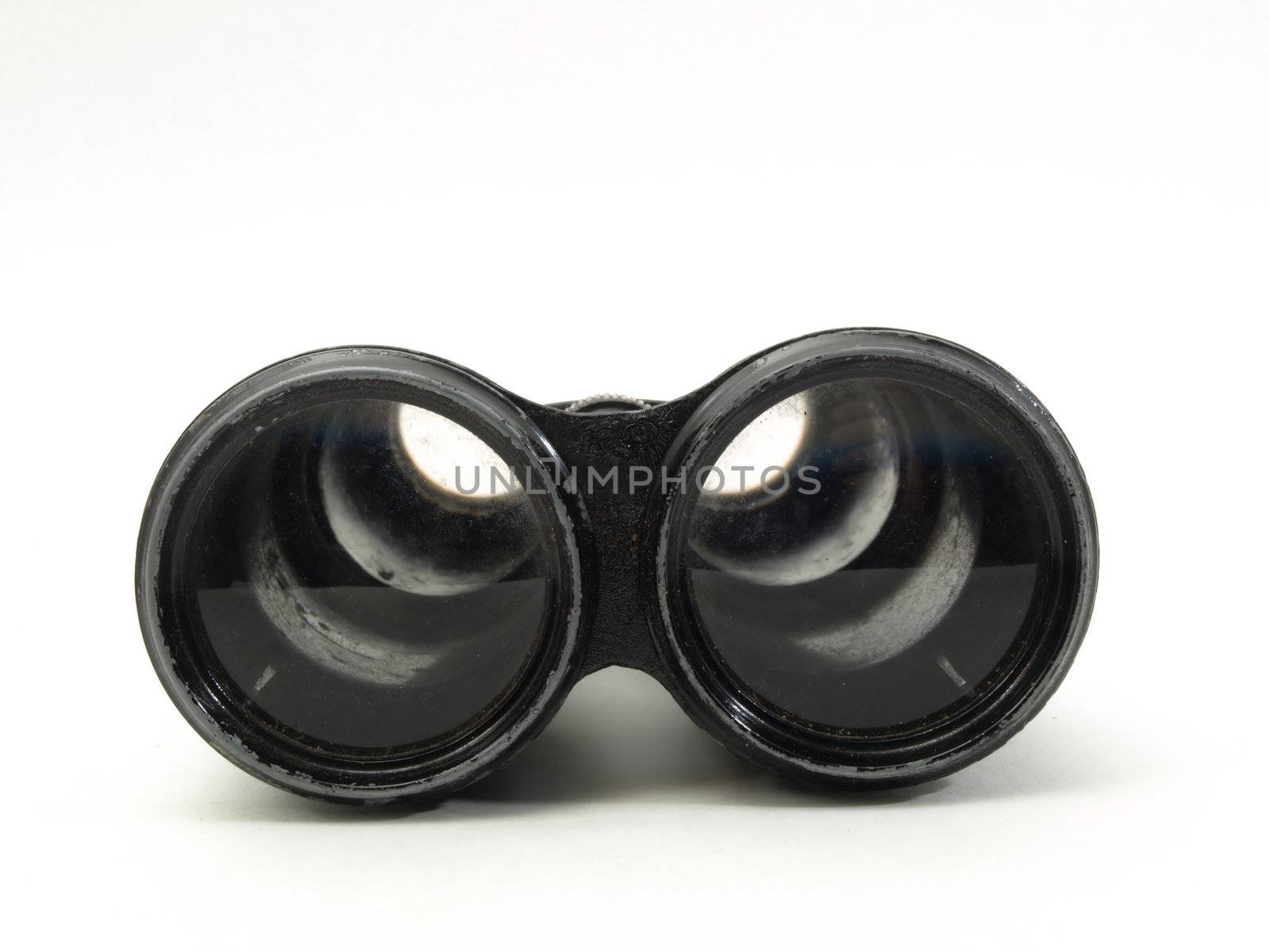 Antique black military issue field binoculars isolated on a white background.