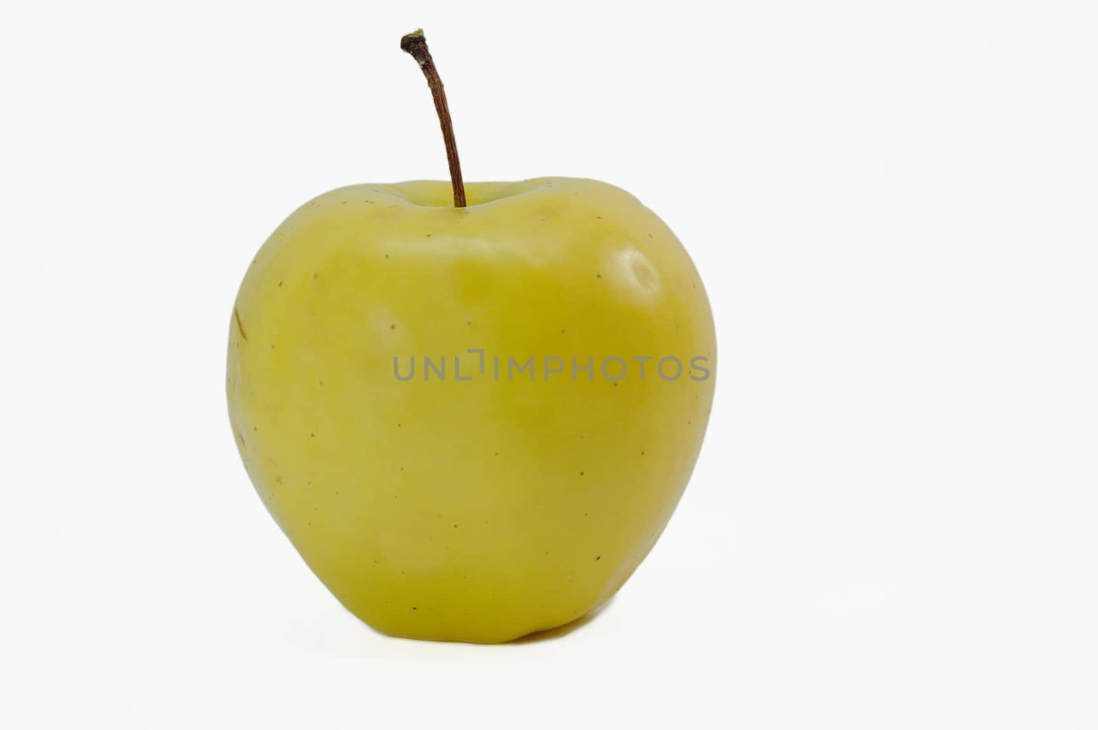 yellow apple isolated on slightly grey