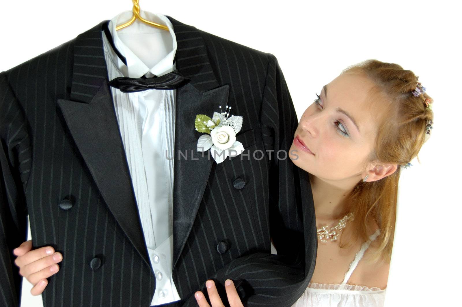 bride looking at her bridegroom's tail coat