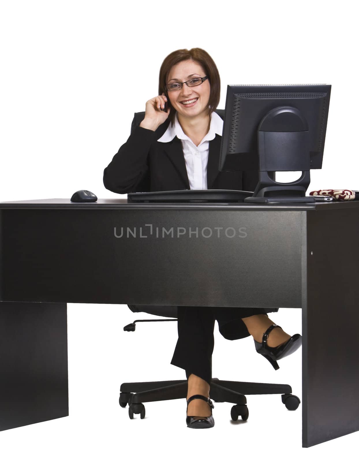 Happy businesswoman ather office desk on the mobile phone.