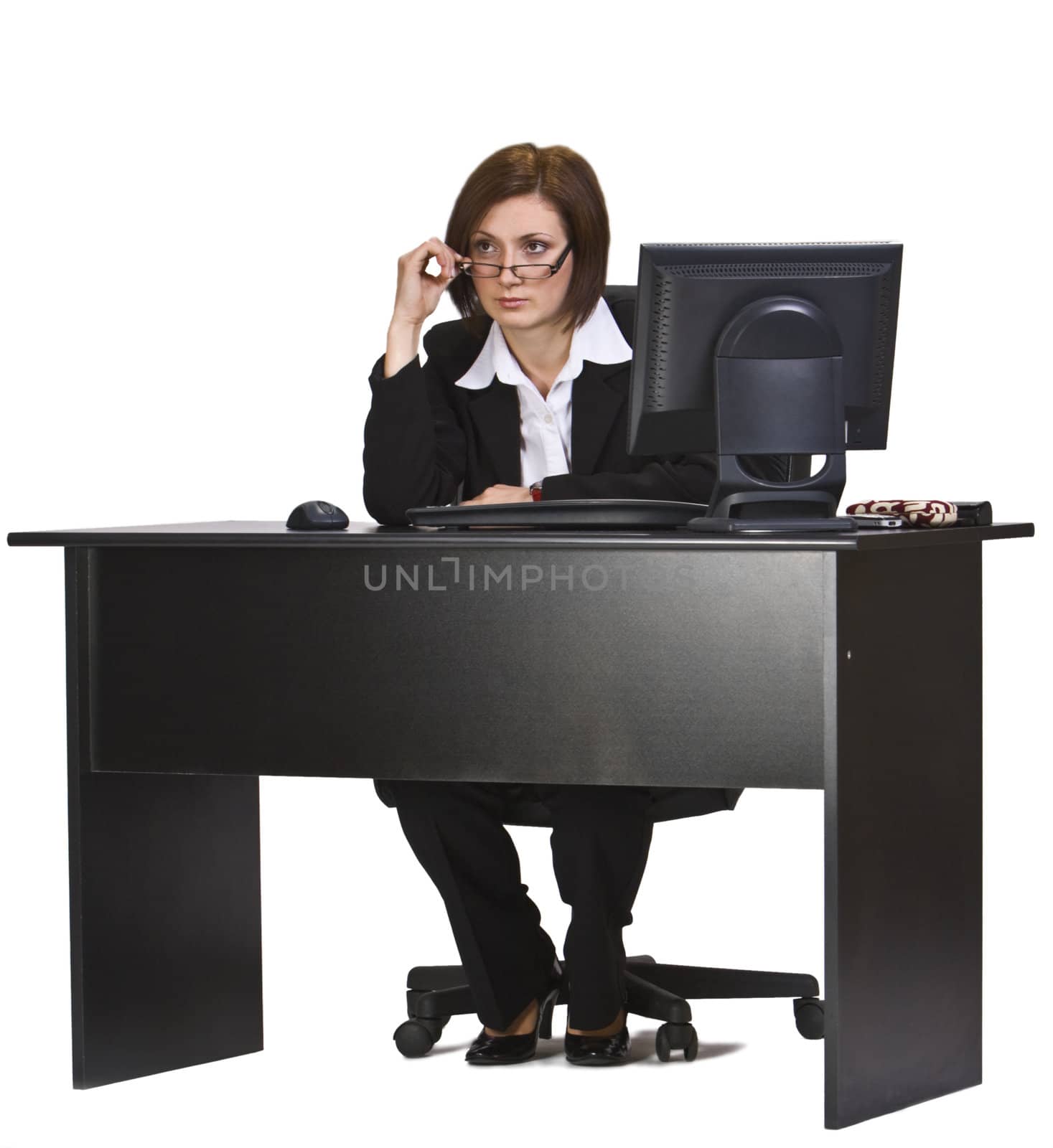 Businesswoman at her office desk looking over the glasses.