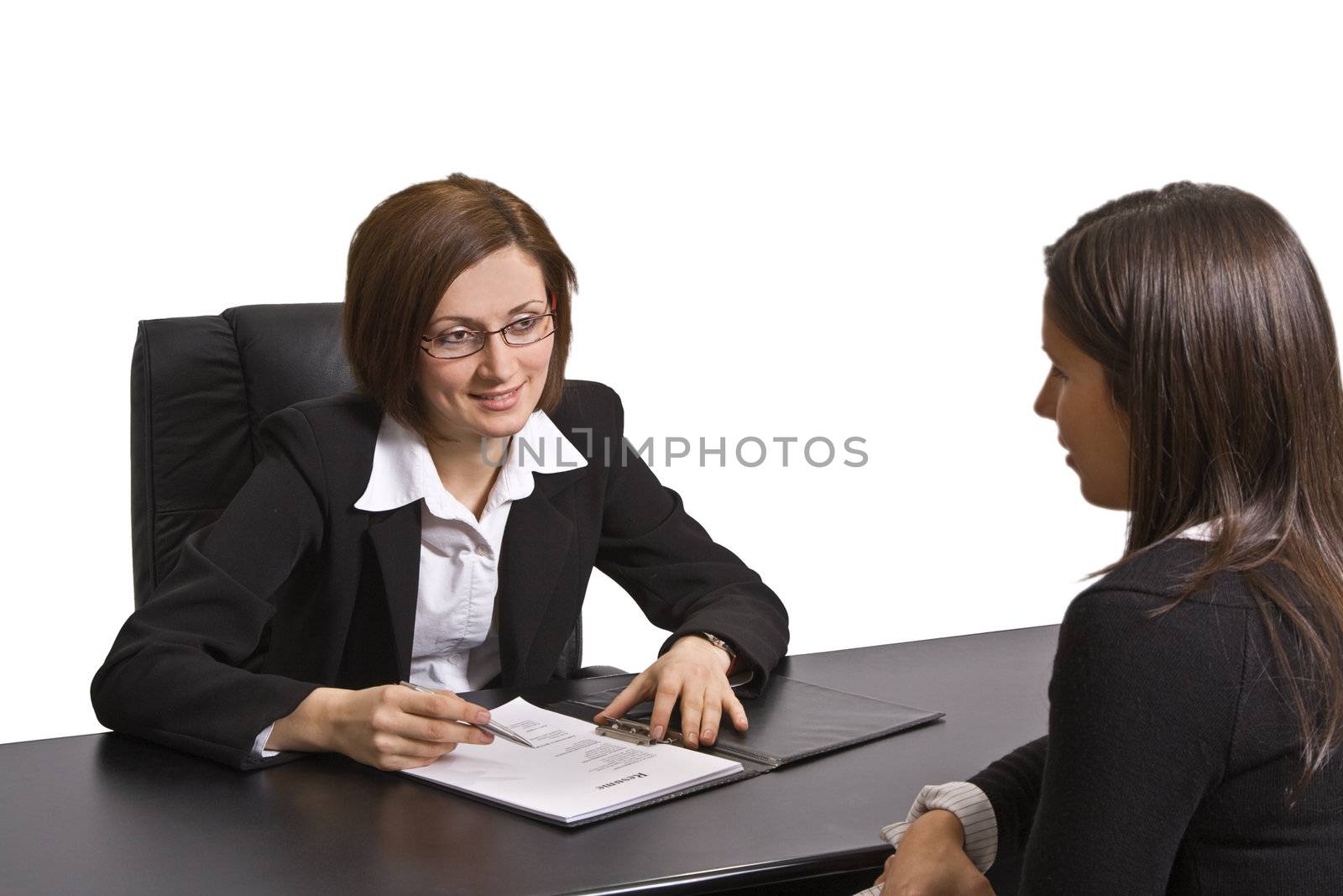 Two businesswomen at an interview in an office.The documents on the desk are mine.