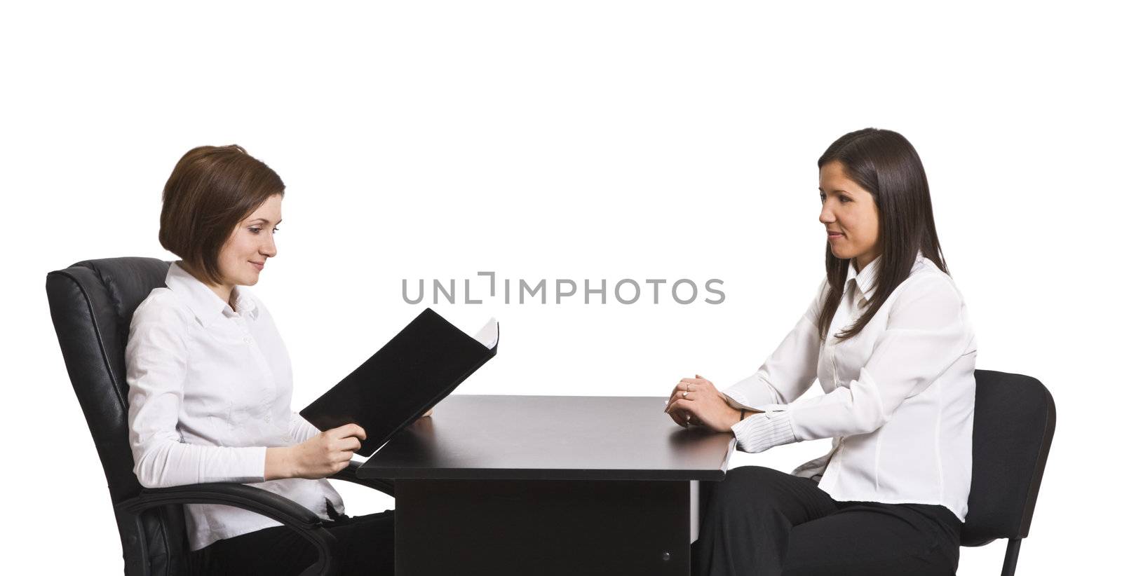 Two businesswomen at an interview in an office isolated against a white background.