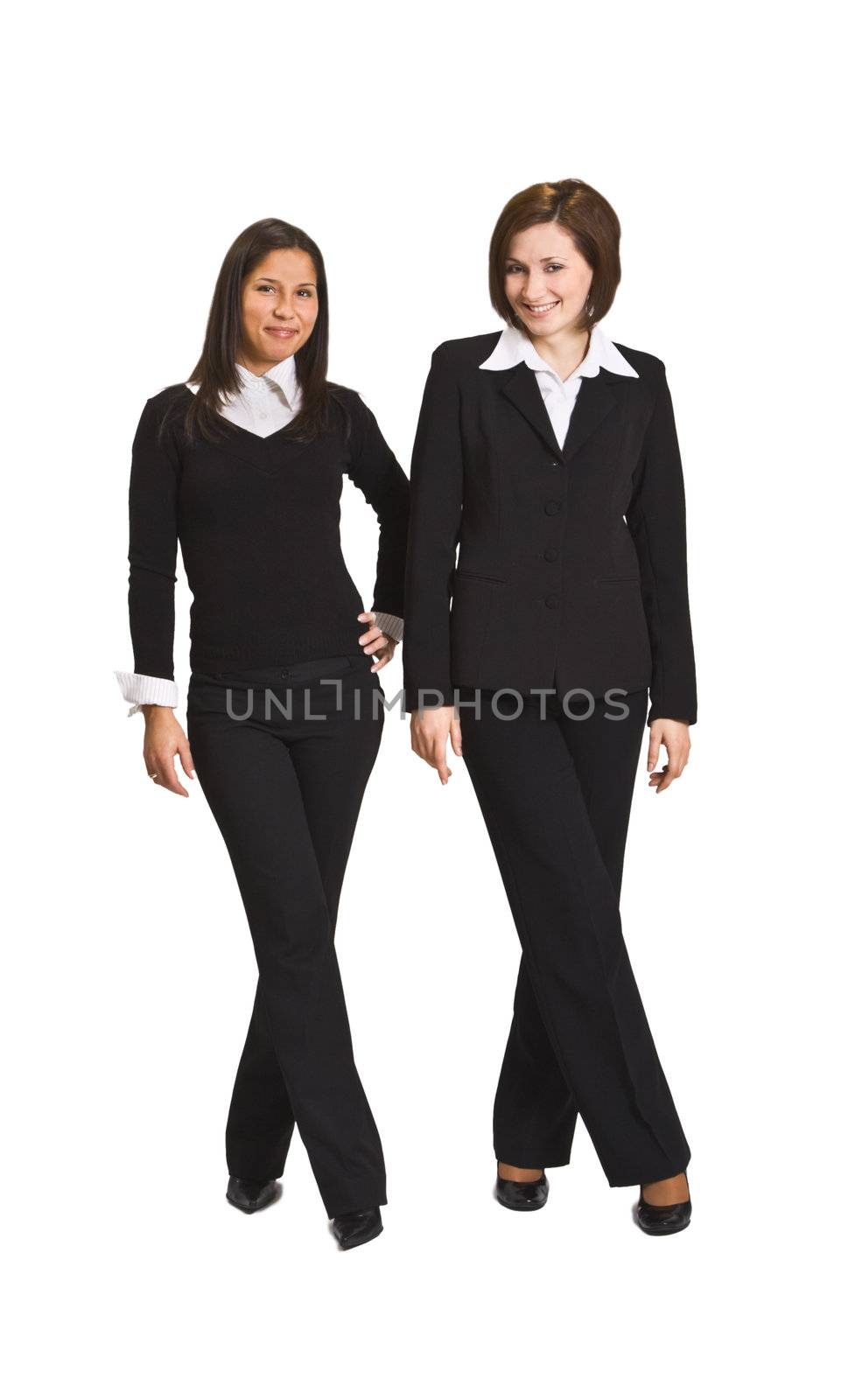 Two relaxed businesswoman standing against a white background.