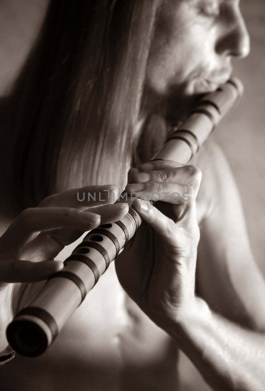 A man playing his wind instrument with expression