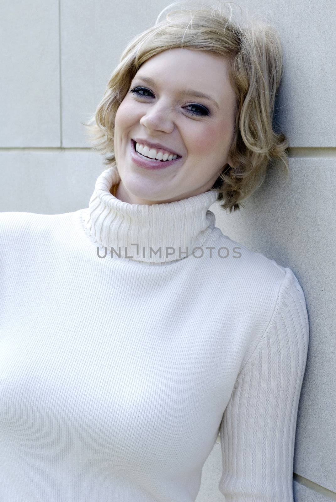 A beautiful model on a white brick building.