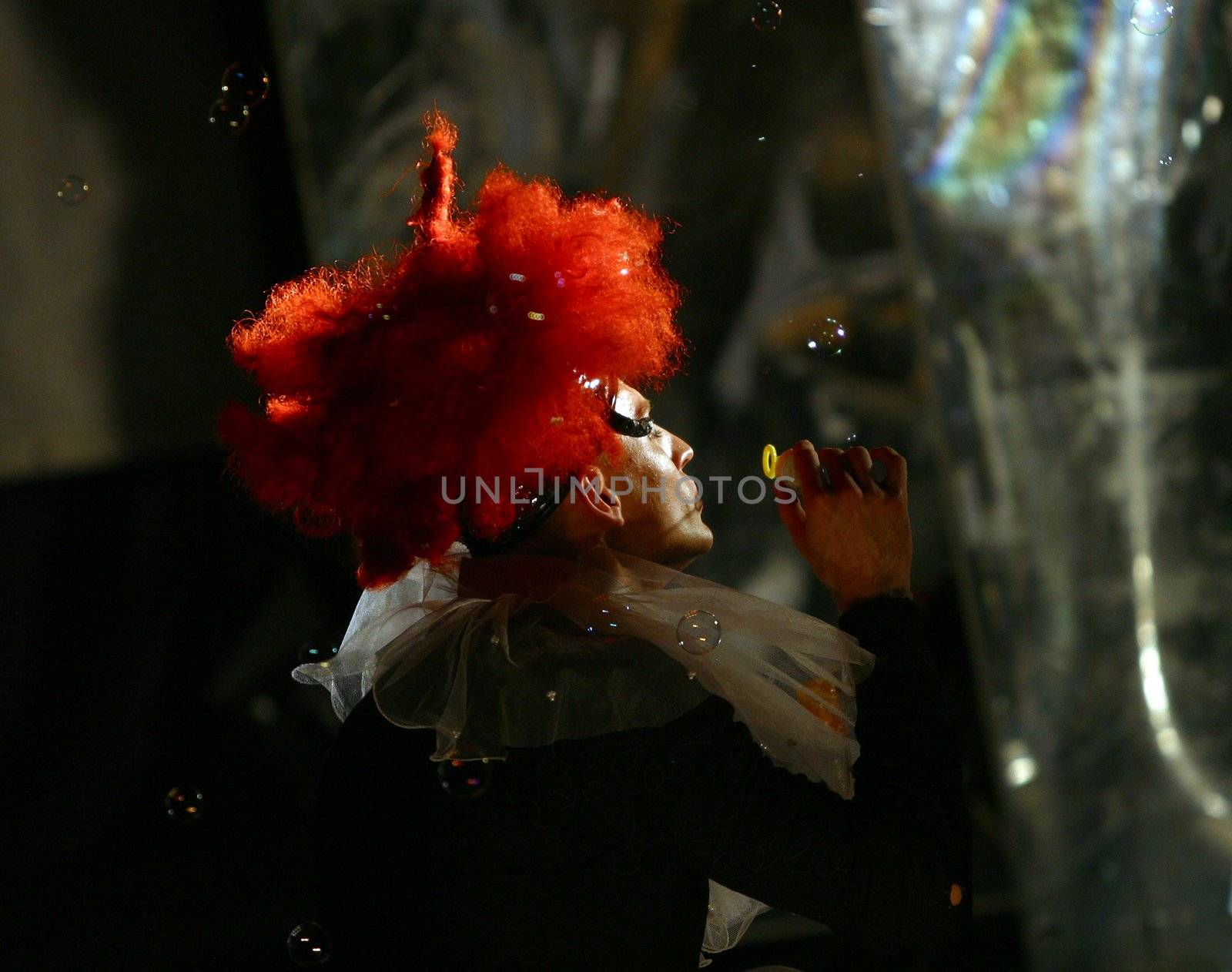 The image of the actor on a stage with soap bubbles