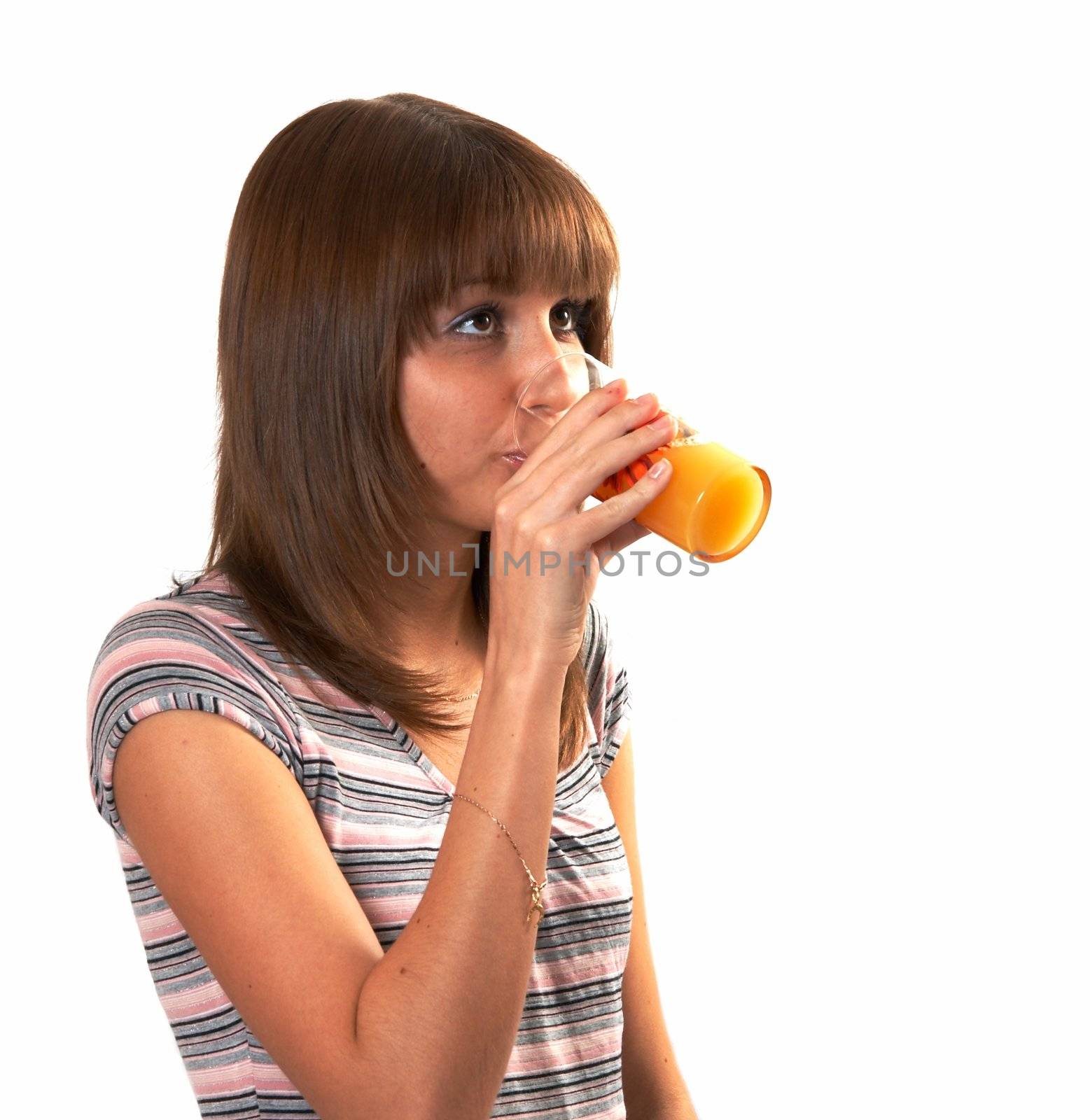 The girl drinking juice on a white background 