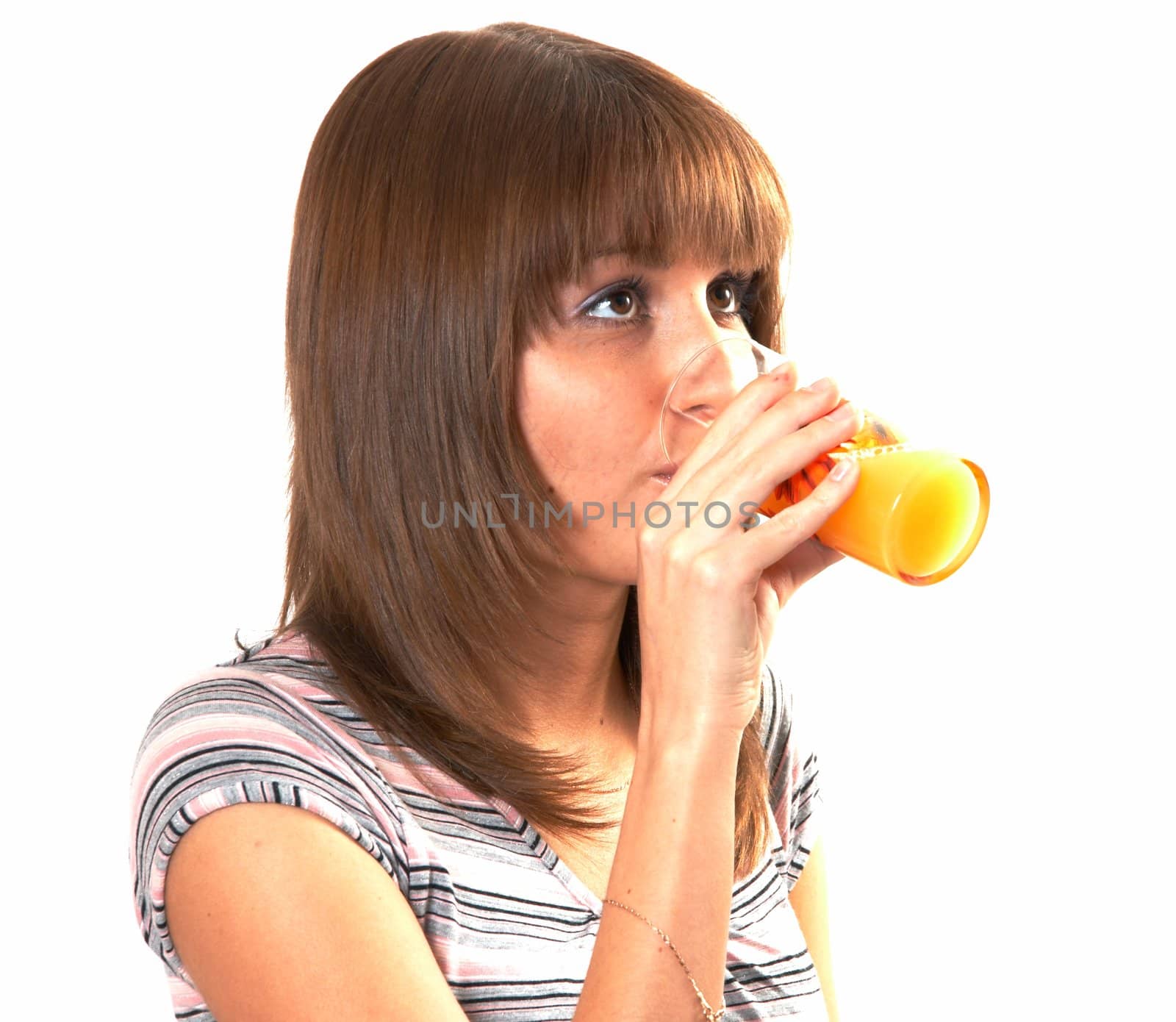 The girl drinking juice on a white background 