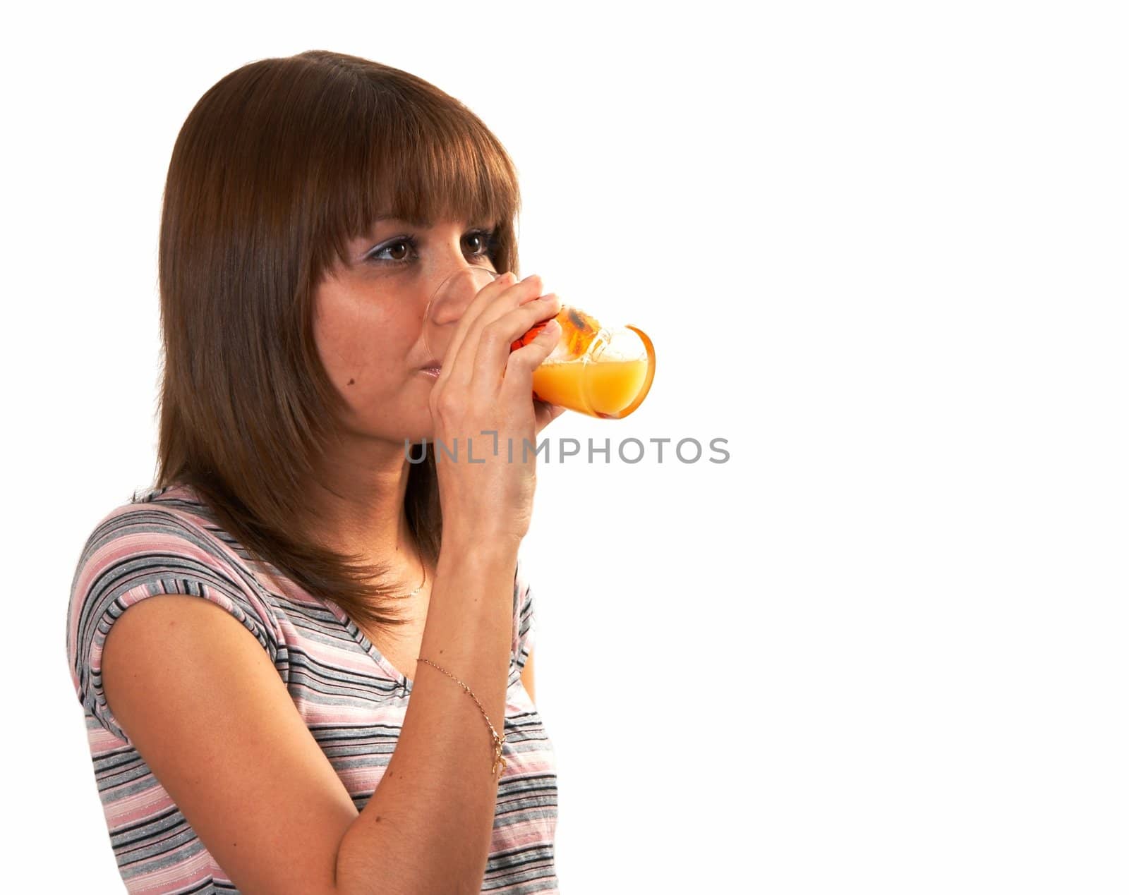 The girl drinking juice on a white background 