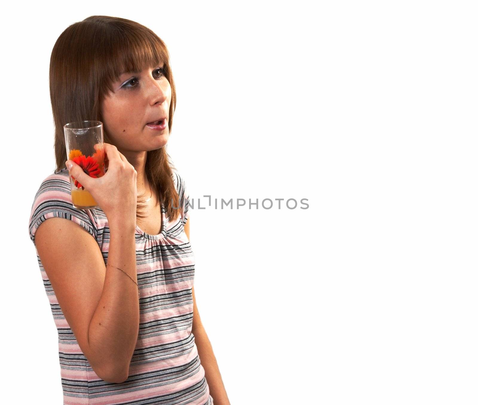 The girl drinking juice on a white background 