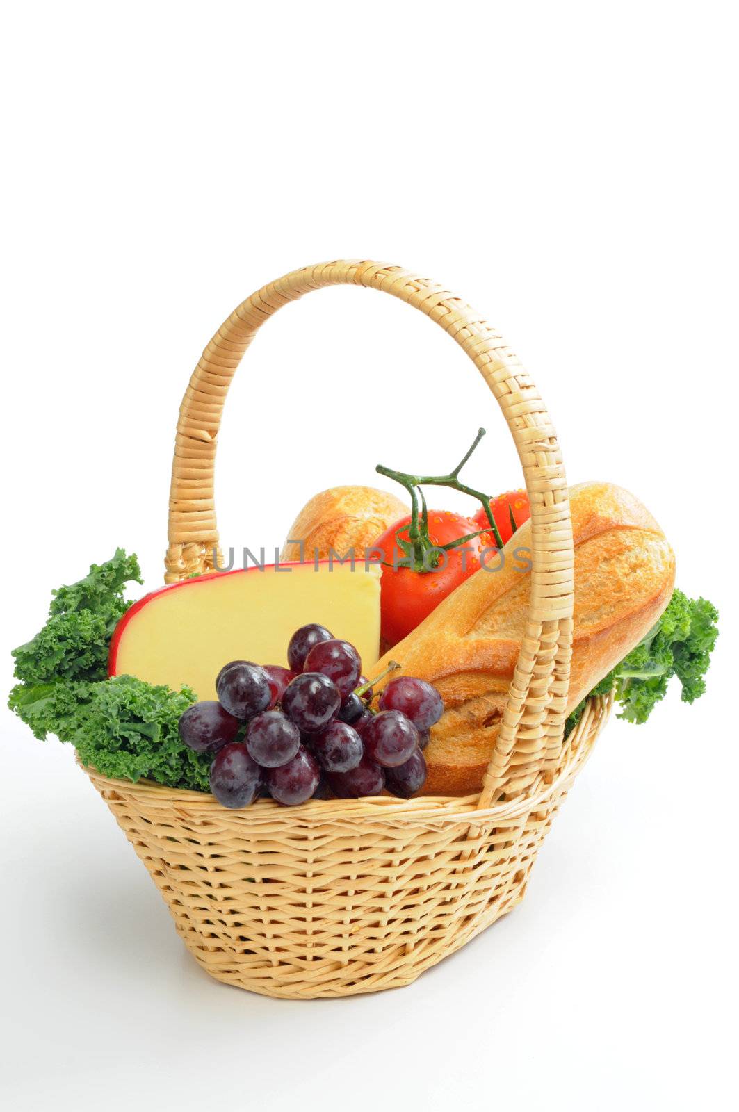 Basket of fresh bread, cheese, fruits and vegetables.