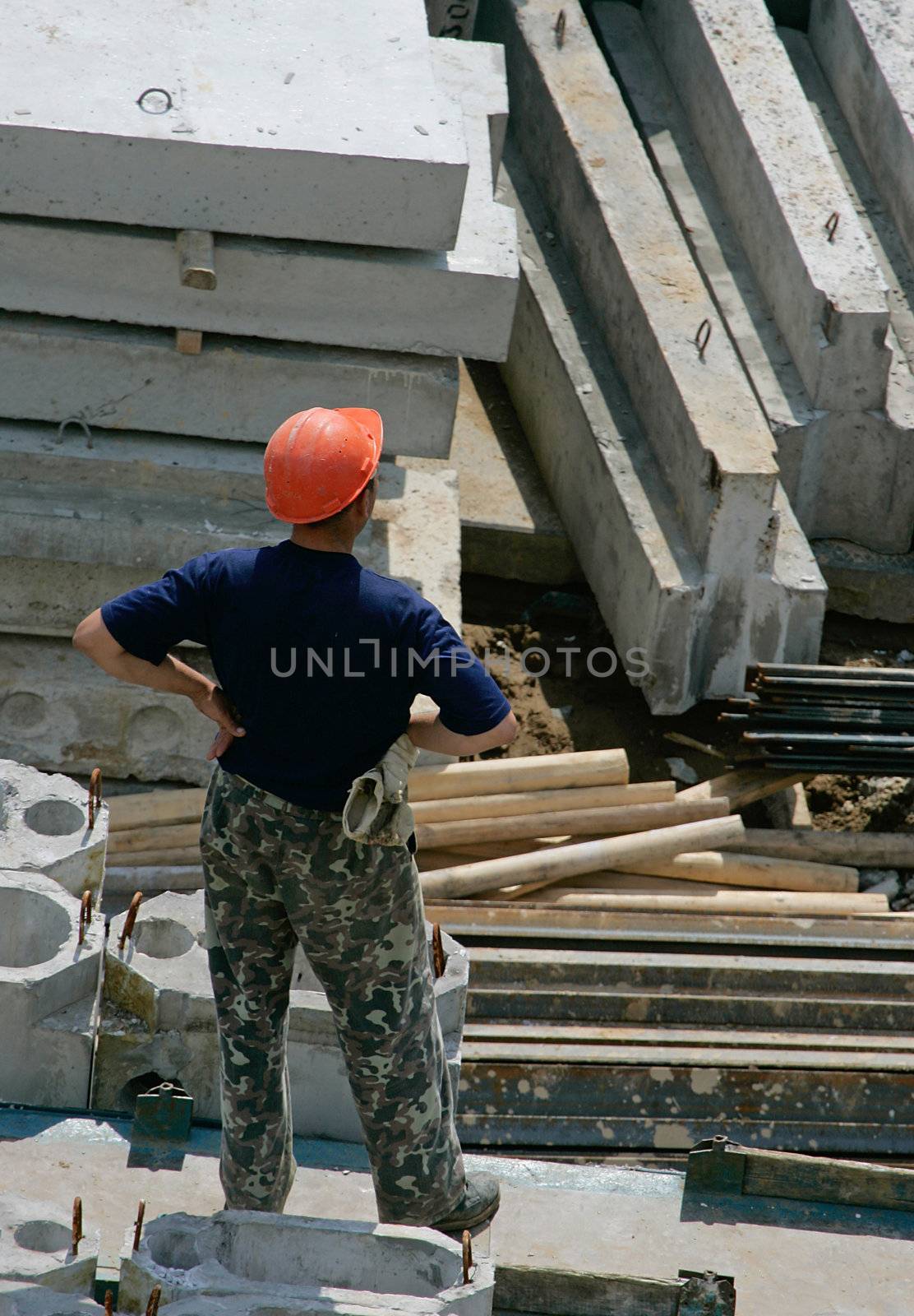 The builder stands among concrete plates