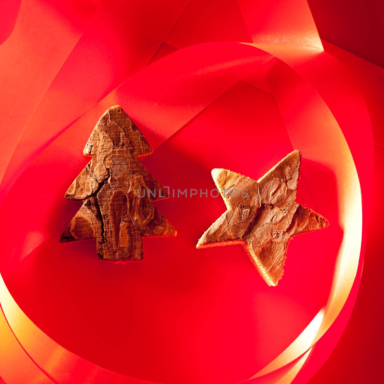 Christmas tree and star of tree bark on red background and ribbon