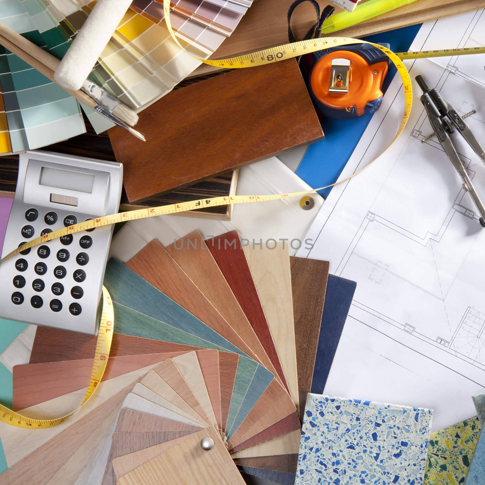 Architect or interior designer workplace desk and design tools with lots of construction material samples