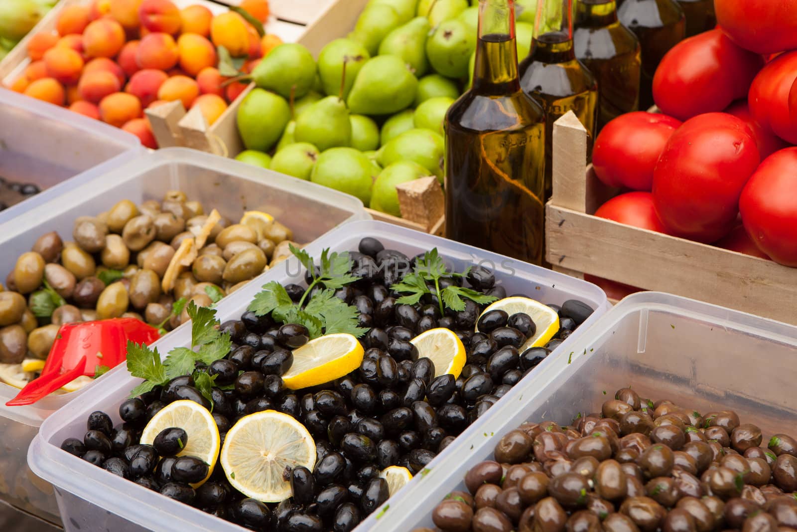 Fresh olives and olive oil for sale at a market