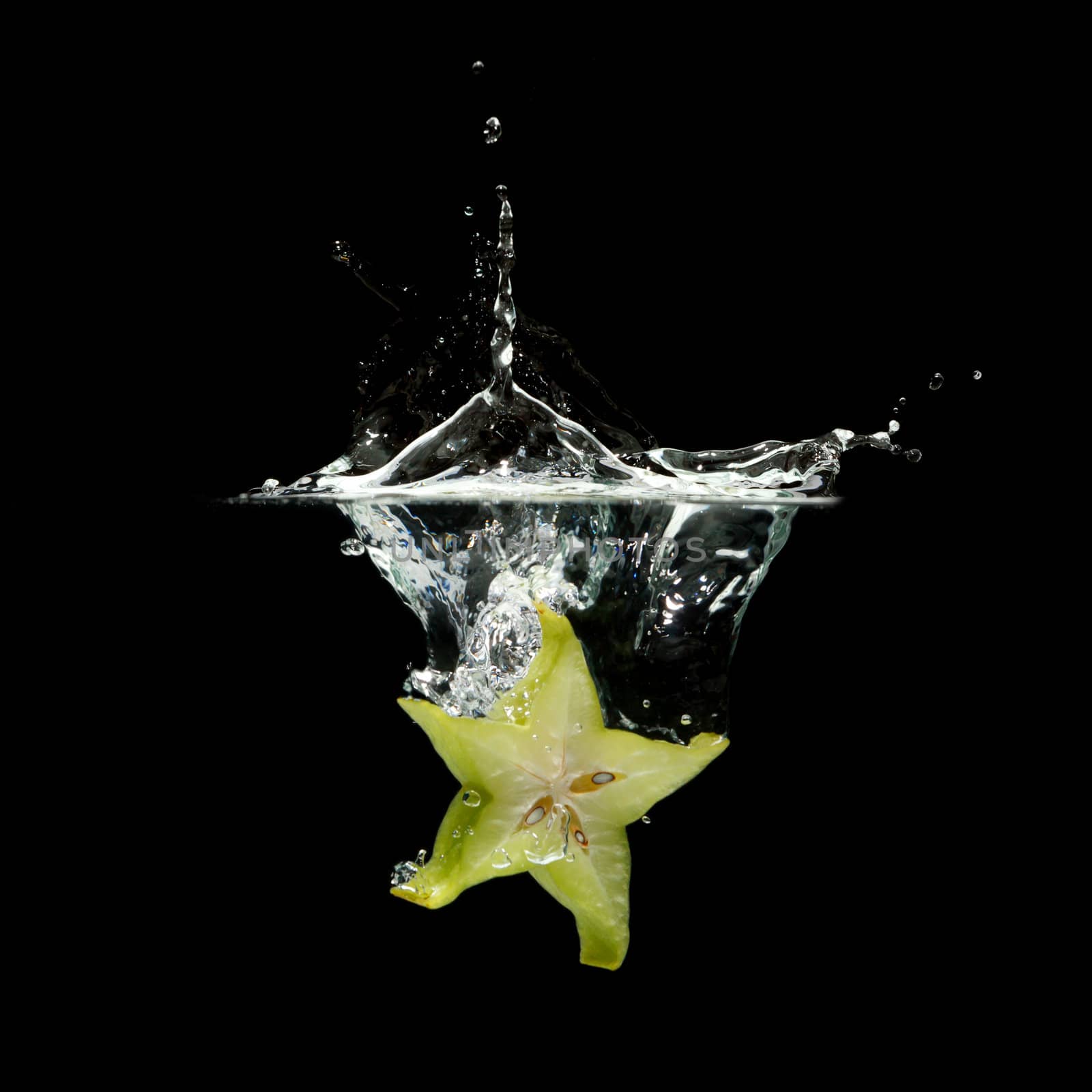 carambola splashing in water by Discovod