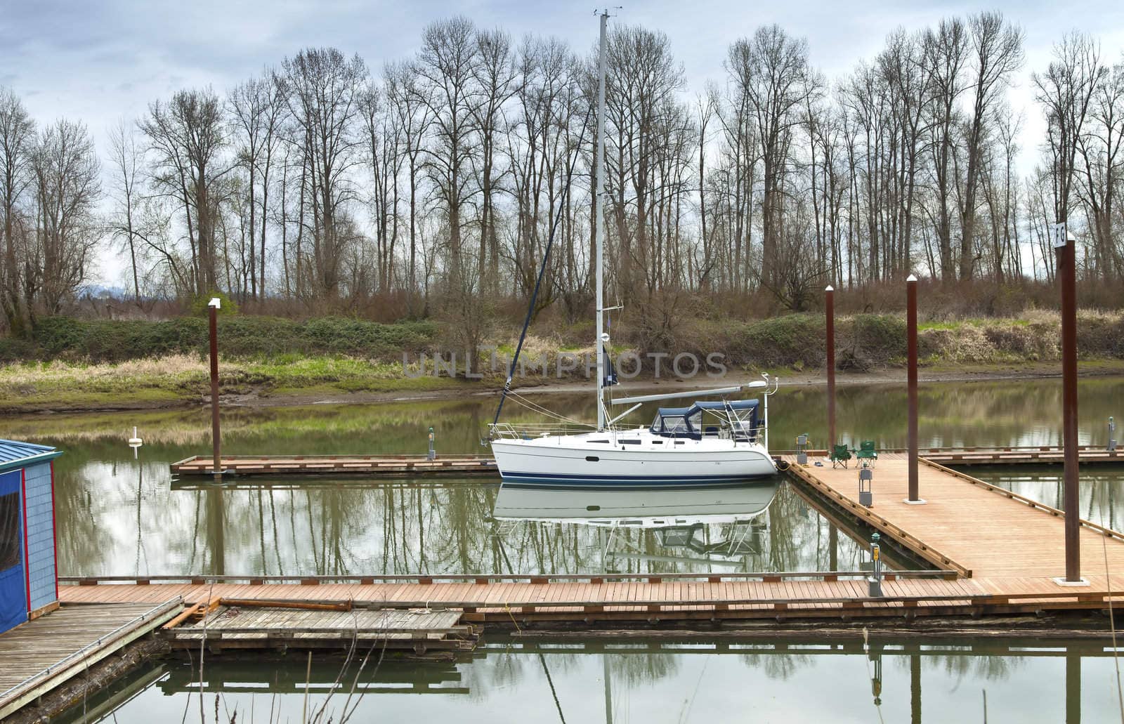 White sailboat moored in a river, Oregon. by Rigucci