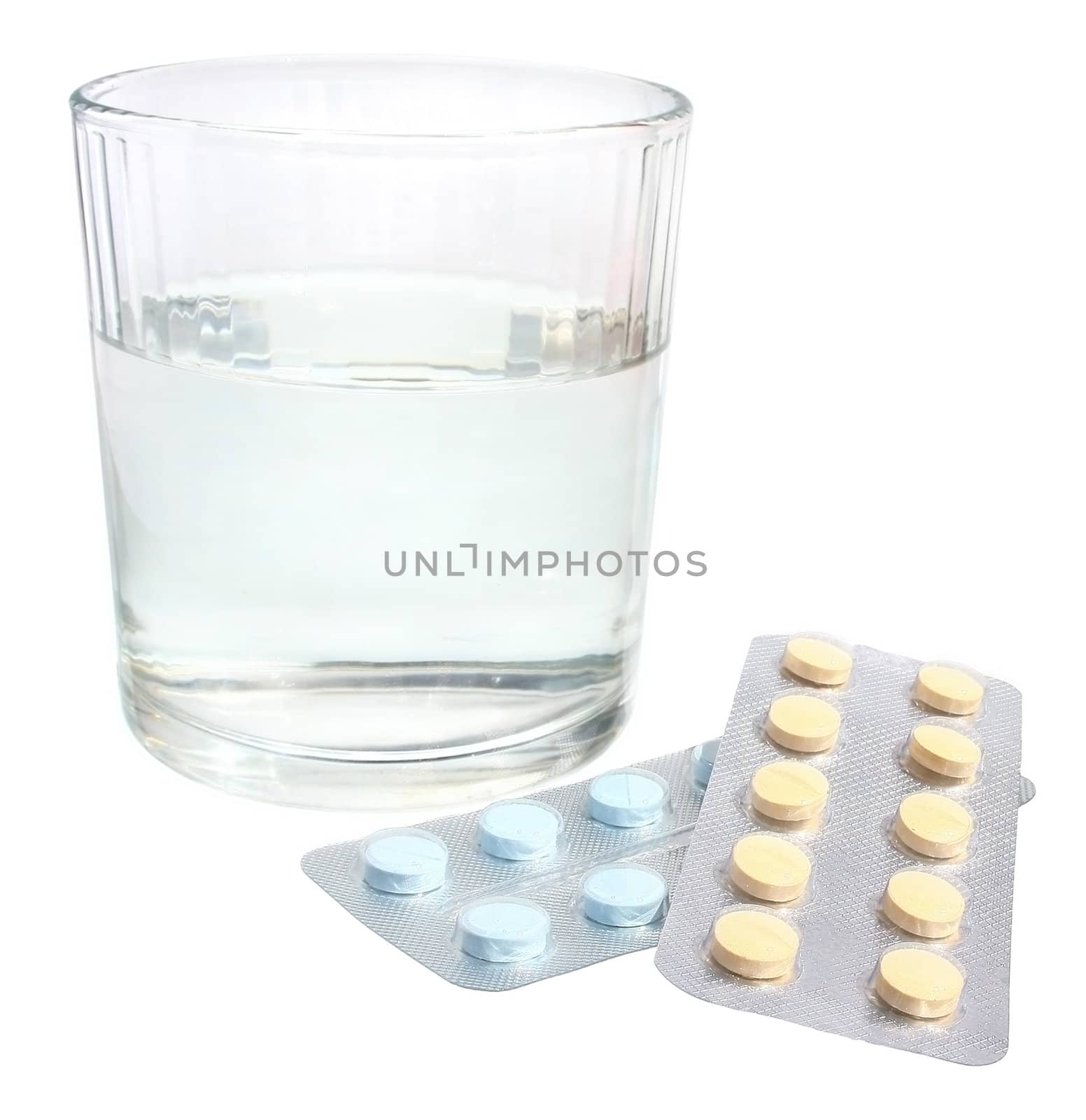 Glass and pills on a white background.