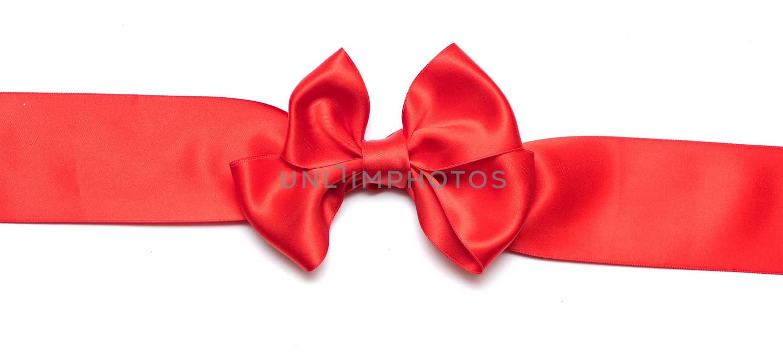 Red ribbon with bow on white 