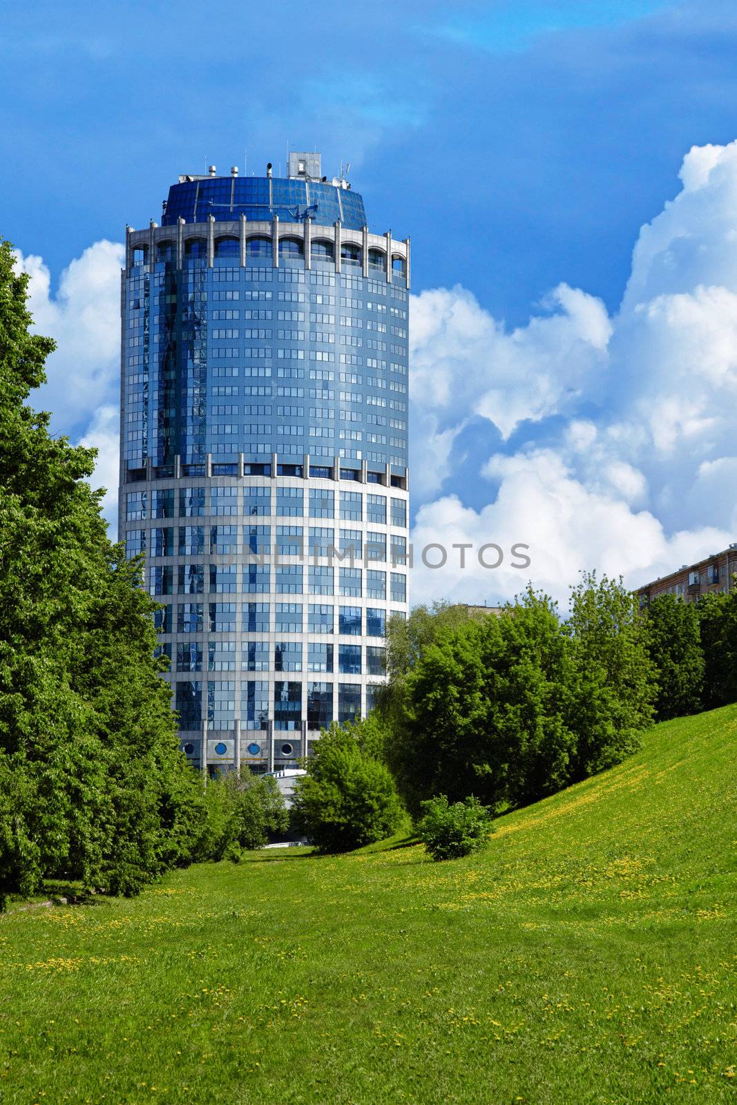 Beautiful, modern building in the shape of the tower - the view from the park