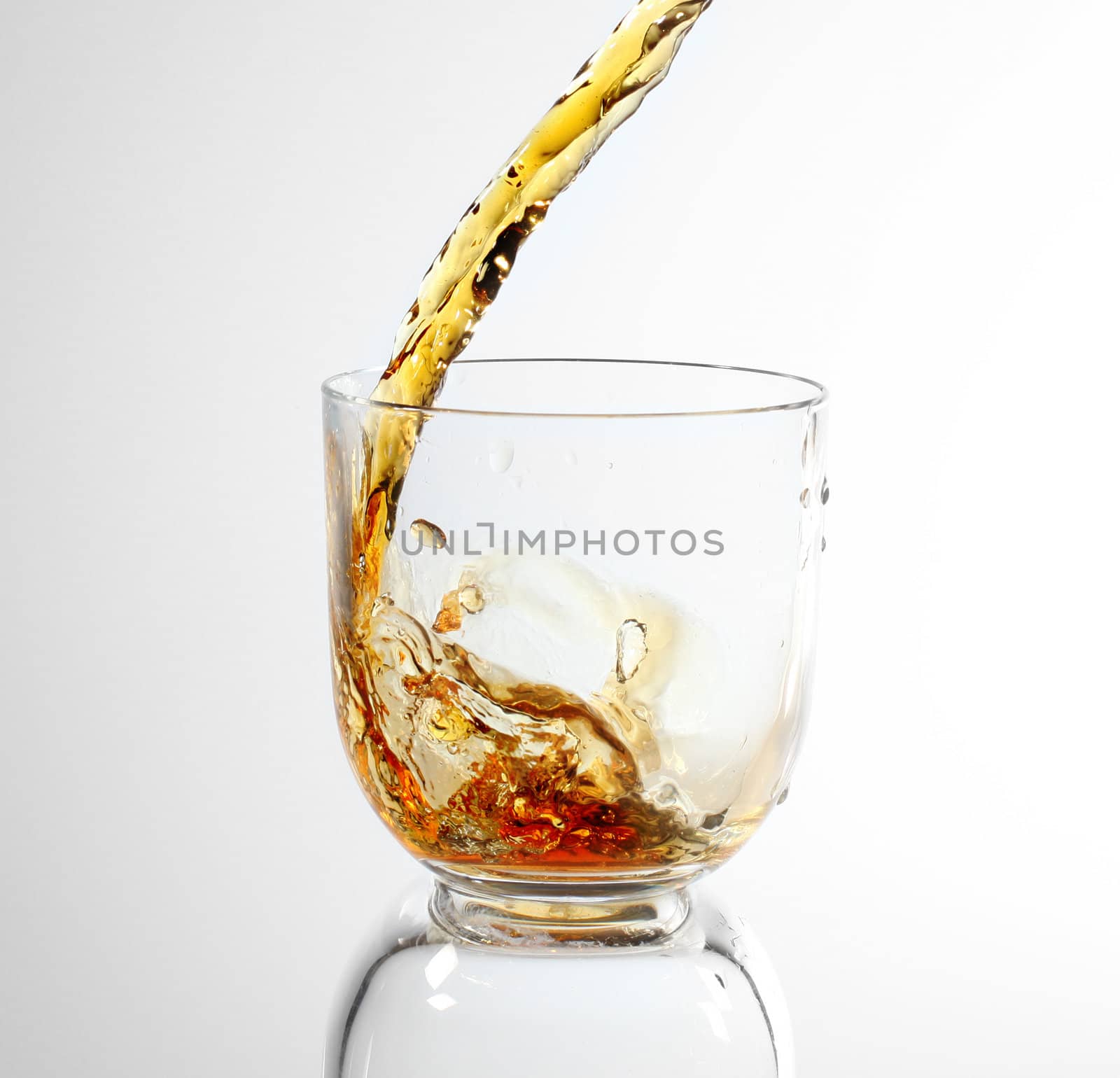 whiskey being poured into a glass by rudchenko