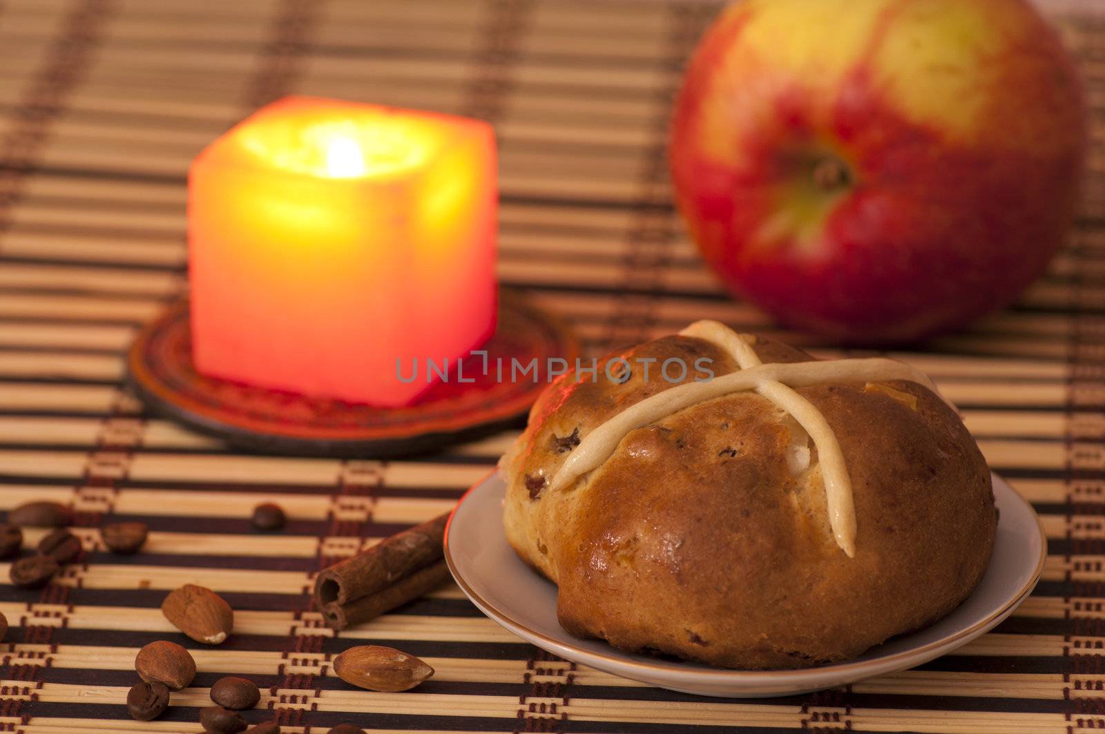 Cross bun with raisins and dried apricots, romantic still life