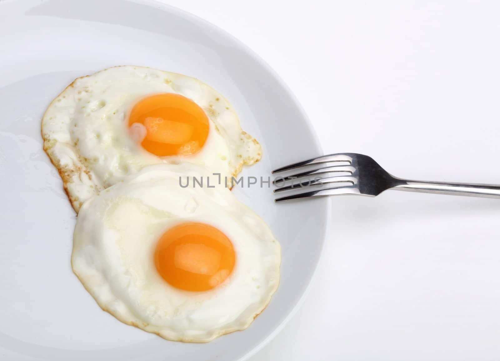 fried eggs with fork by rudchenko