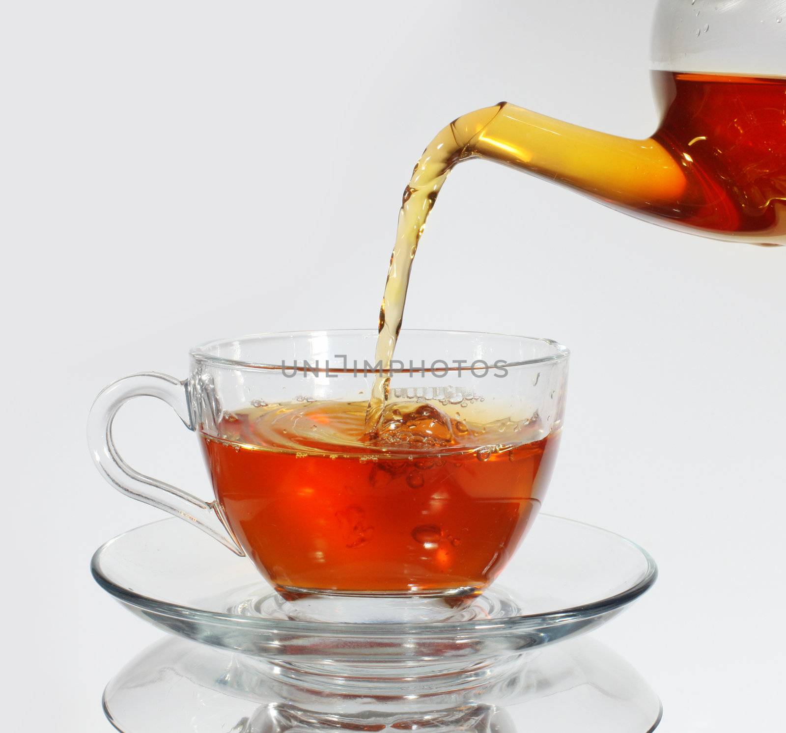 Pouring tea to a teacup