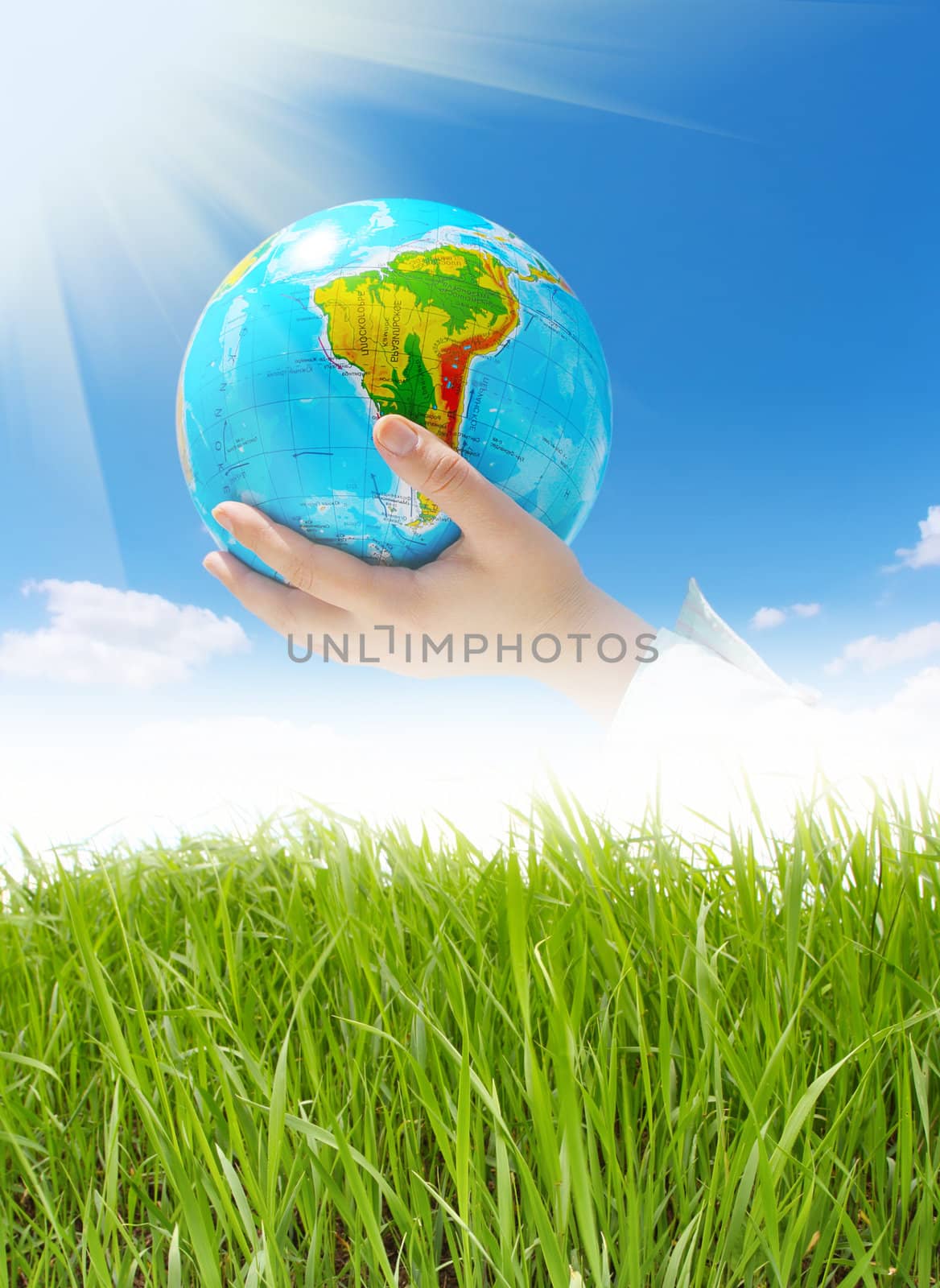 globe in hands under blue sky by rudchenko