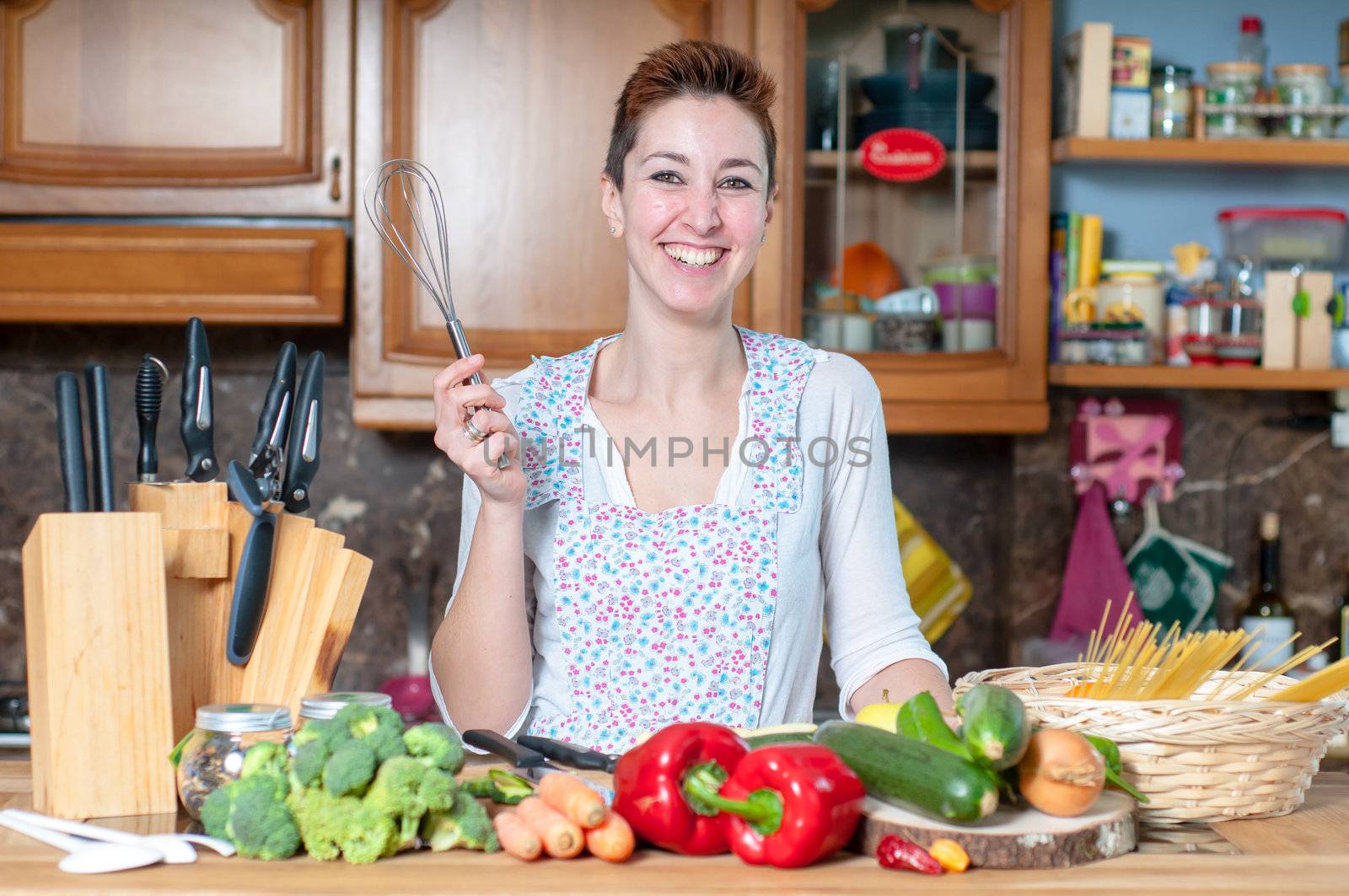 beautiful housewife cooking vegetables in the kitchen
