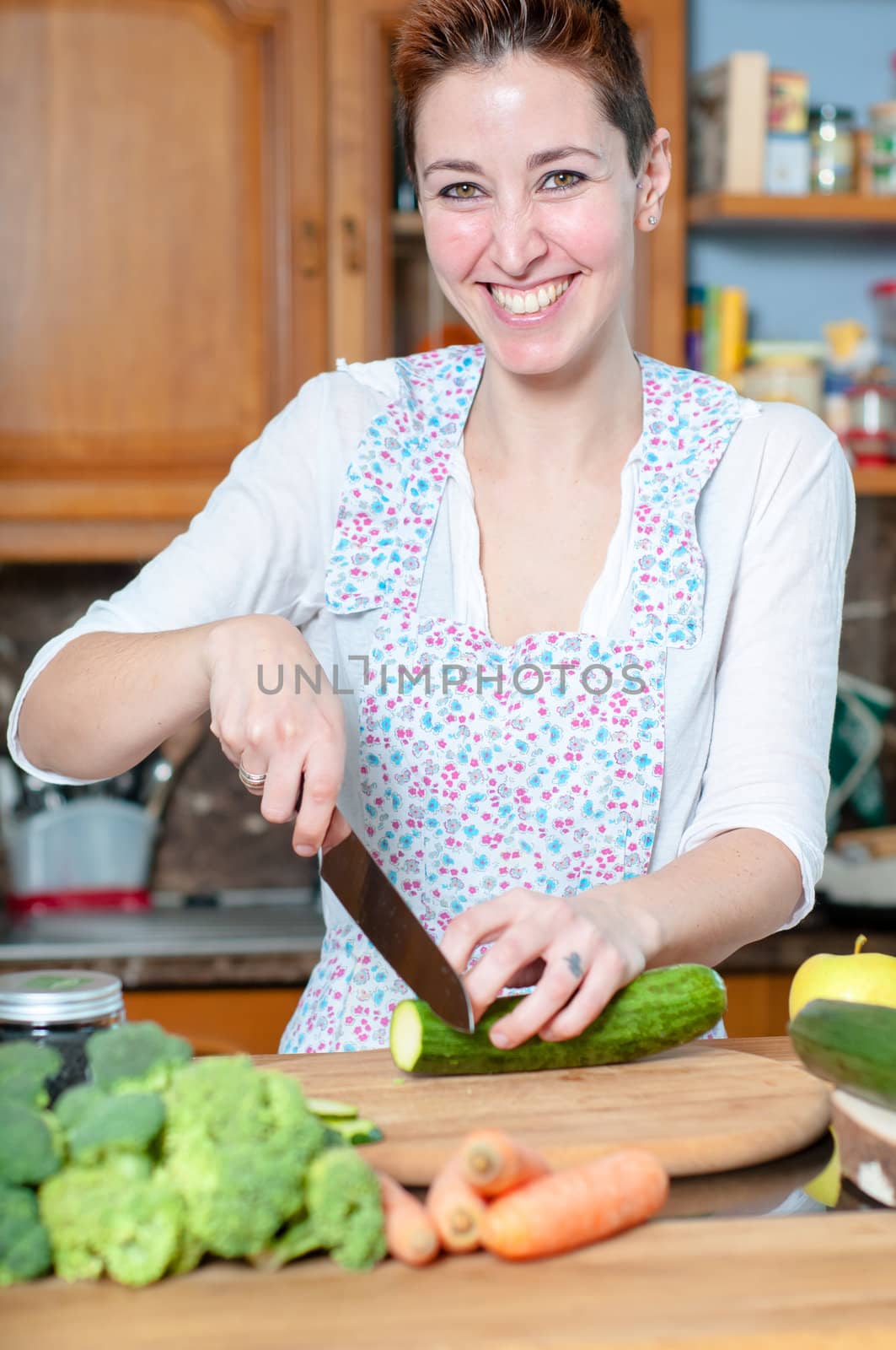 beautiful housewife cooking vegetables in the kitchen