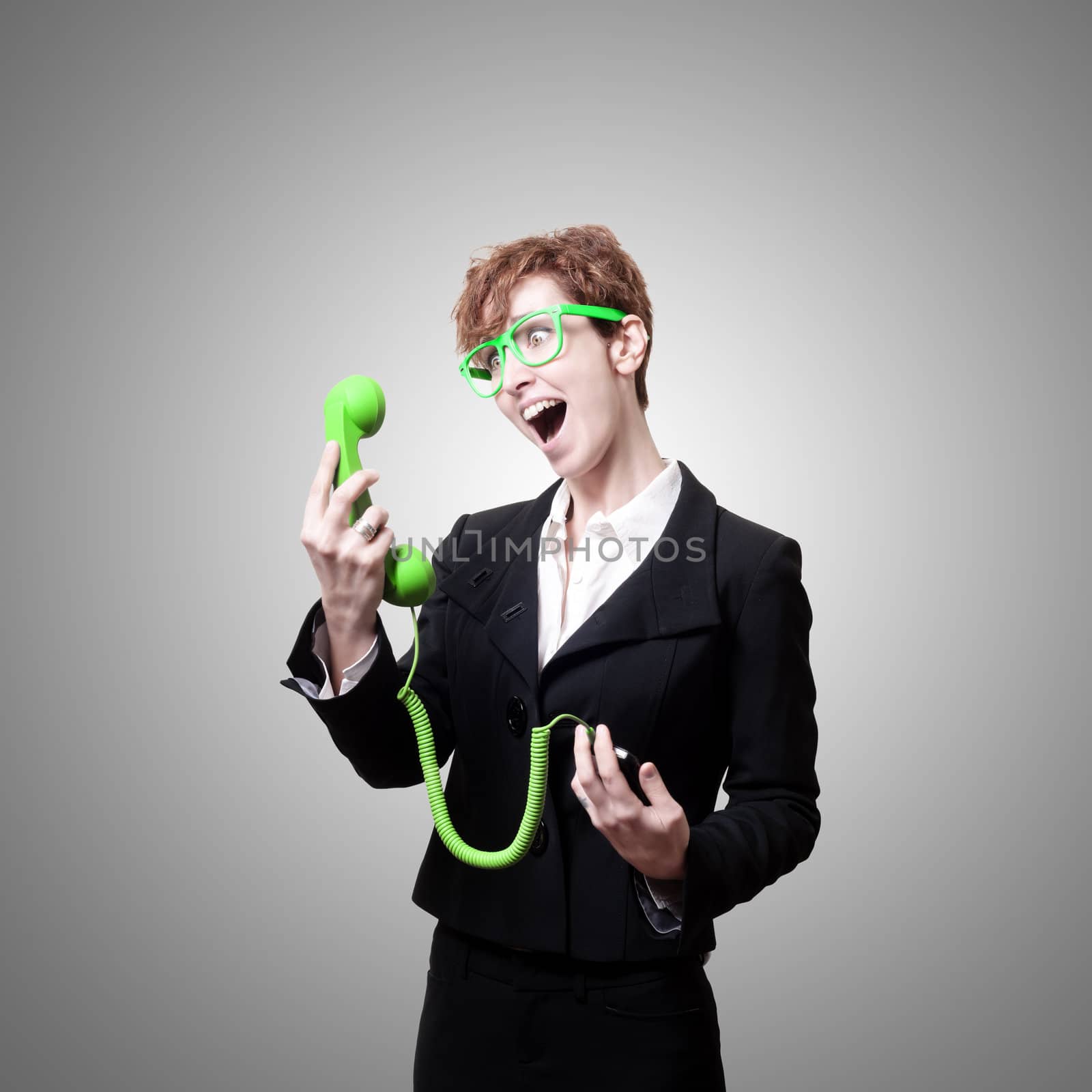 business woman with phone on gray background