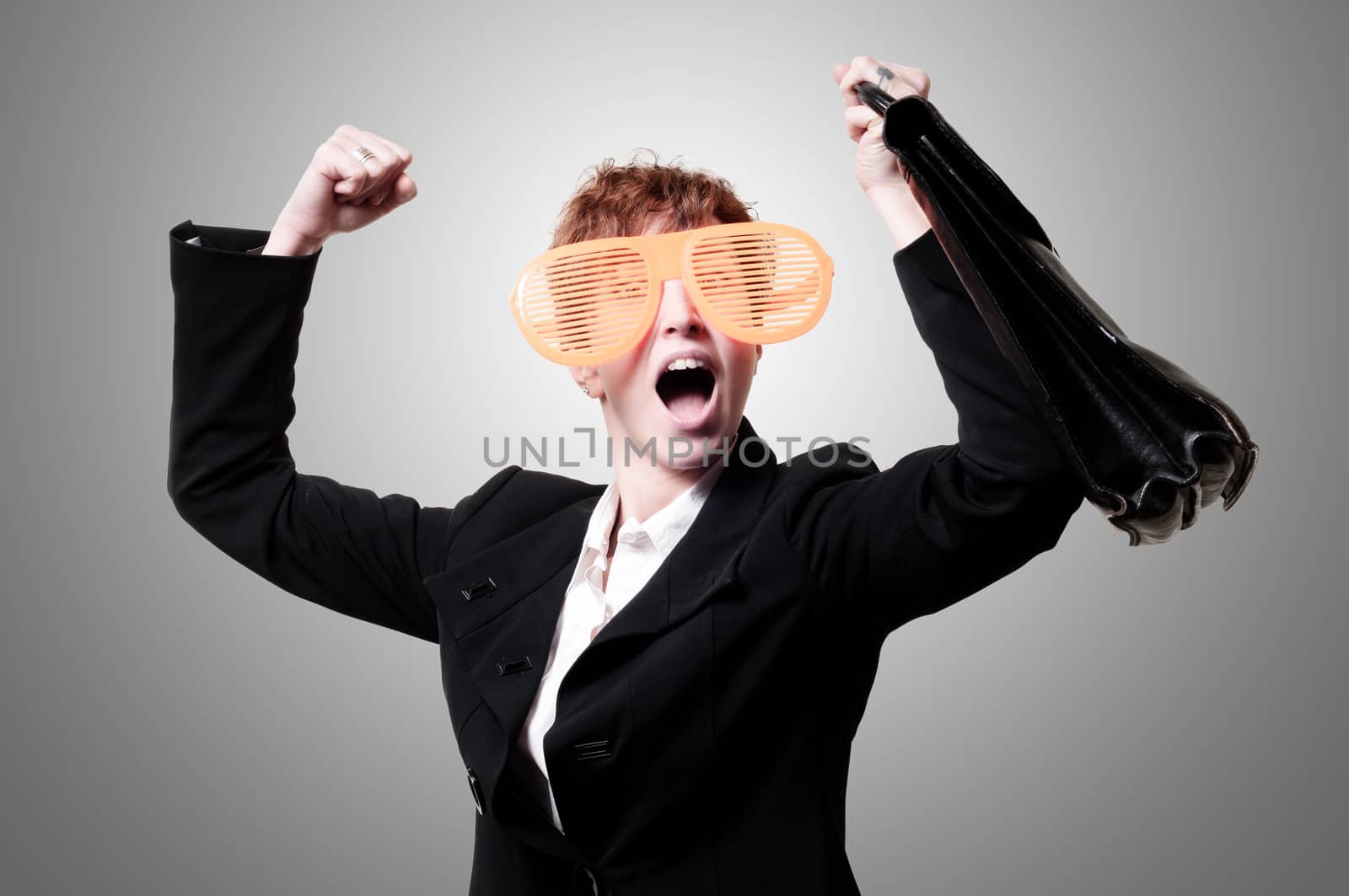 businesswoman with big funny eyeglasses and briefcase on gray background