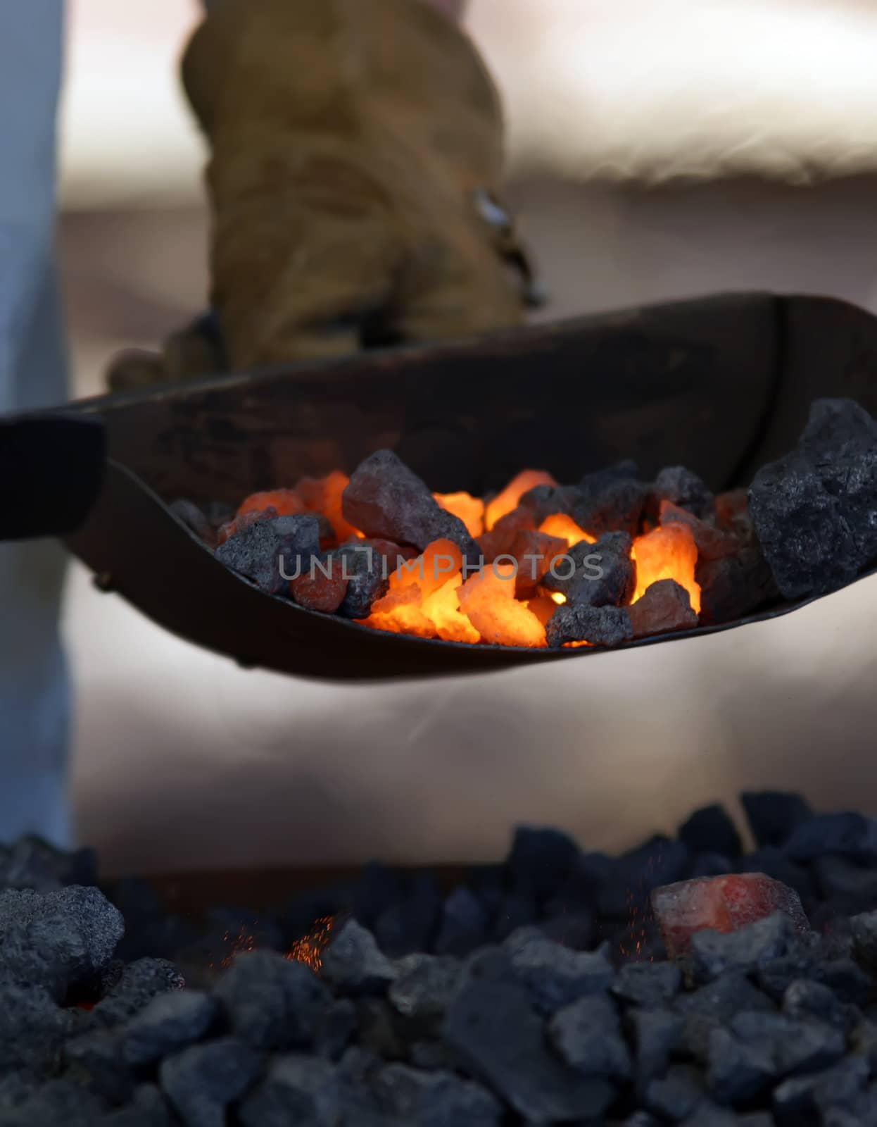 iron smith working near hot coal