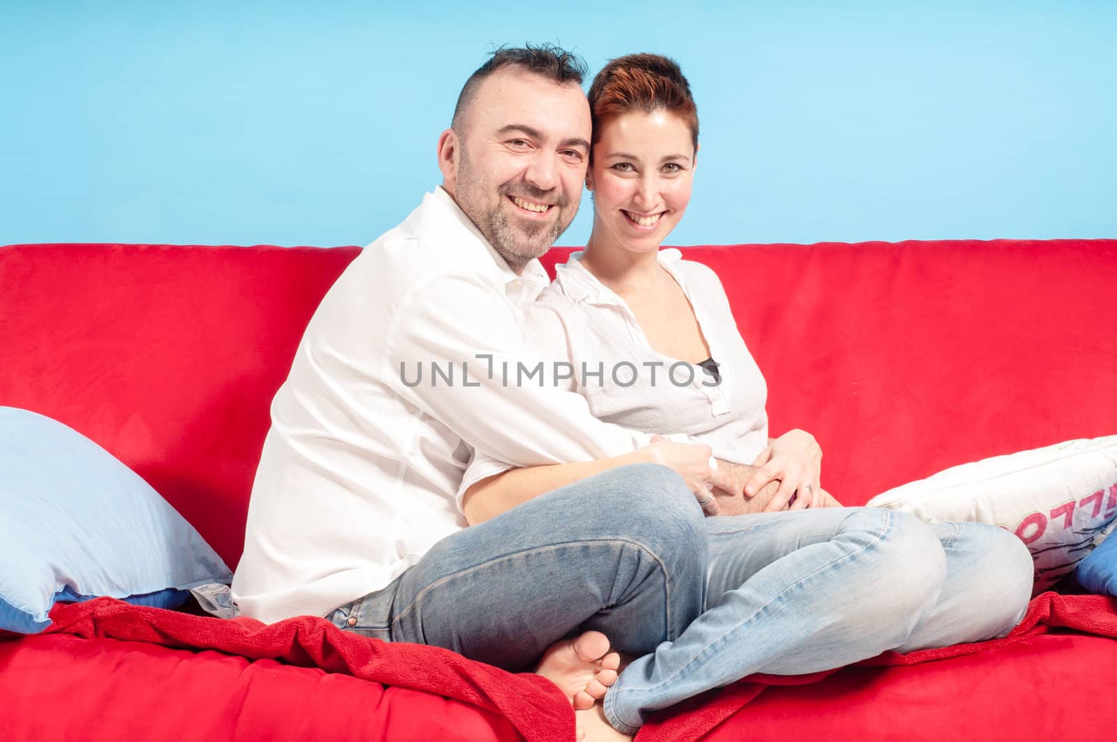 husband and wife hugging on the couch in the living room