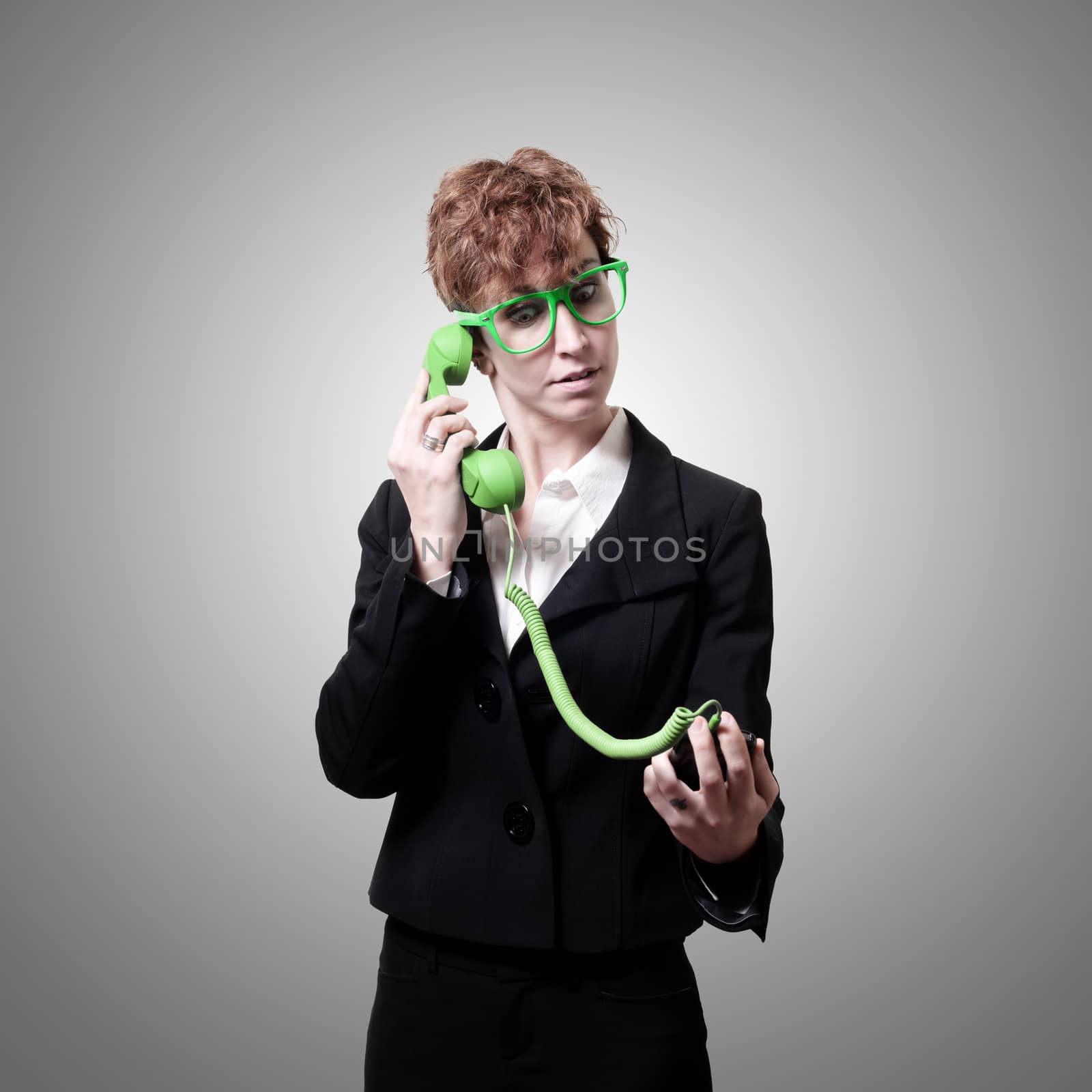 business woman with phone on gray background